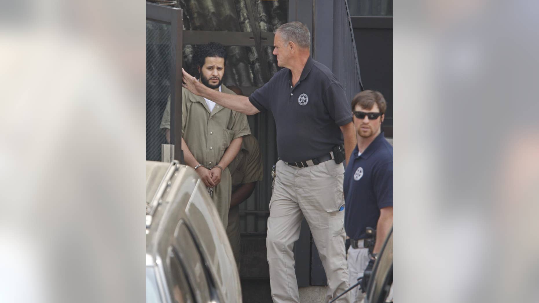 US Marshall's lead Mufid A. Elfgeeh, 30, a naturalized U.S. citizen from Yemen, out of Federal Court following a hearing Monday, June 1, 2014 in Rochester. The Rochester man was indicted Tuesday Sept. 16, 2014 on charges that he tried to provide material support to the Islamic State by helping three men who said they would travel to Syria to “engage in violent jihad” alongside the group’s militants, according to the Justice Department. (AP Photo/Democrat & Chronicle, Shawn Dowd)