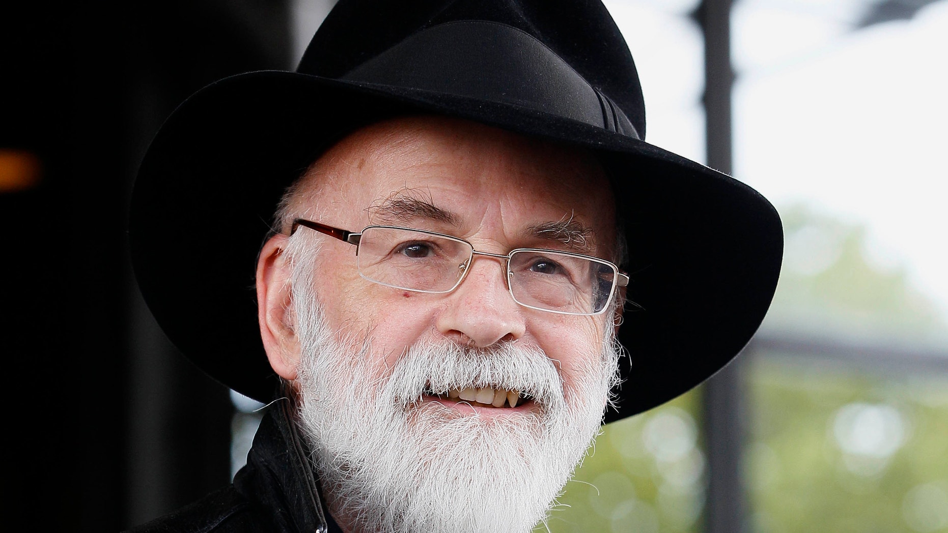 This is a Tuesday, Oct. 5, 2010 file photo of British author Terry Pratchett seen at the Conservative party conference in Birmingham, England. Pratchett, creator of the Discworld series, died Thursday March 12, 2015 aged 66.