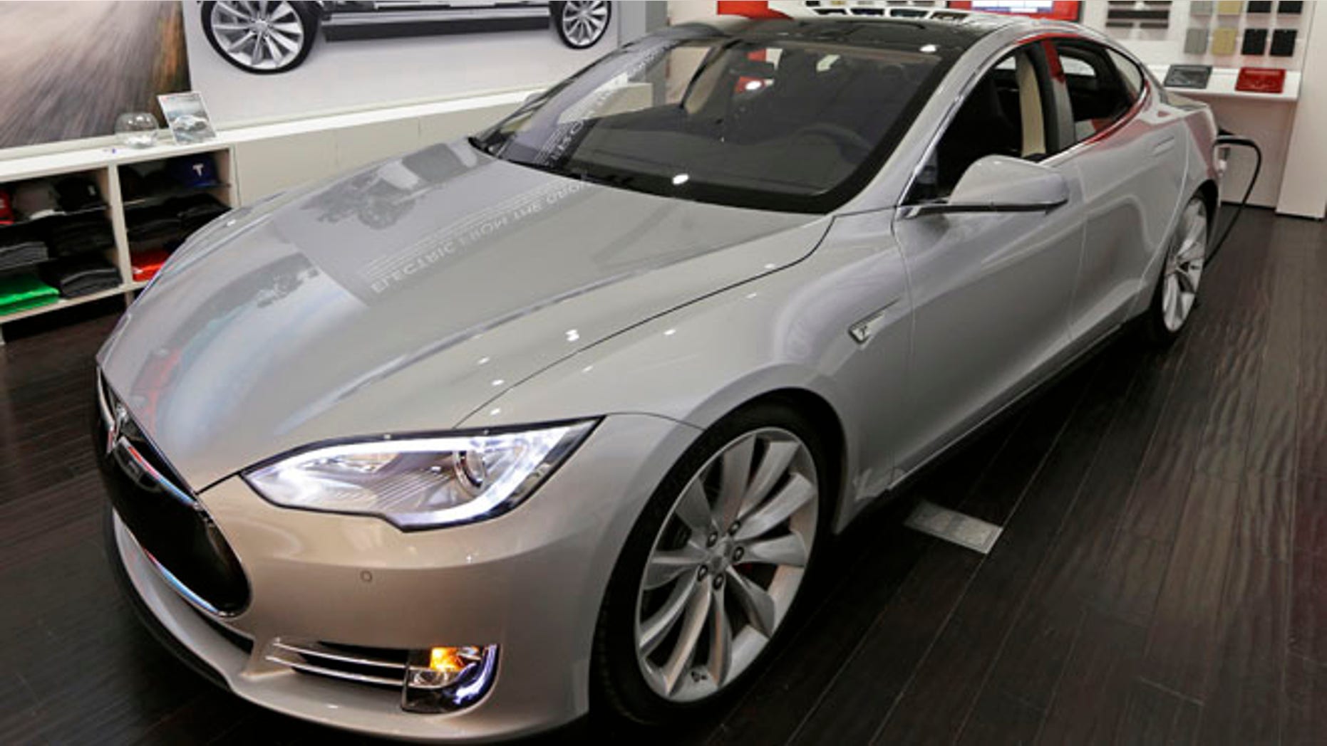 A new Tesla all electric car is on display, Monday, March 17, 2014, at a Tesla showroom inside the Kenwood Towne Centre in Cincinnati. Ohio auto dealers are sparring at the Statehouse with the California-based Tesla, which is selling it's next generation electric cars from three Ohio storefronts. Lawmakers in Ohio and other states are trying to block Tesla direct sales on grounds they undercut traditional auto dealerships. (AP Photo/Al Behrman)