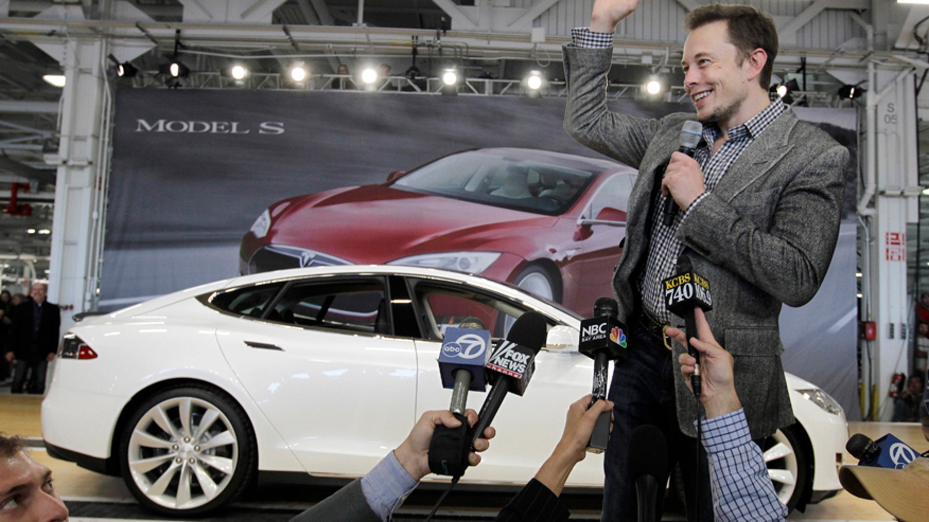 FILE - In this June 22, 2012 file photo, Tesla CEO Elon Musk waves during a rally at the Tesla factory in Fremont, Calif. Musk has five states bidding up subsidy packages to land a coveted plant for a $5 billion factory to make batteries for a new generation of Tesla electric cars. (AP Photo/Paul Sakuma, File)