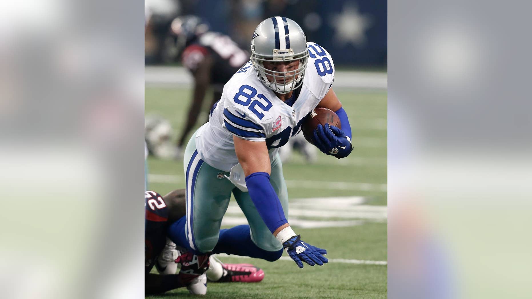 Dallas Cowboys tight end Jason Witten (82) is tackled by Houston Texans cornerback Kareem Jackson (25) during the first half of an NFL football game, Sunday, Oct. 5, 2014, in Arlington, Texas. (AP Photo/Brandon Wade)