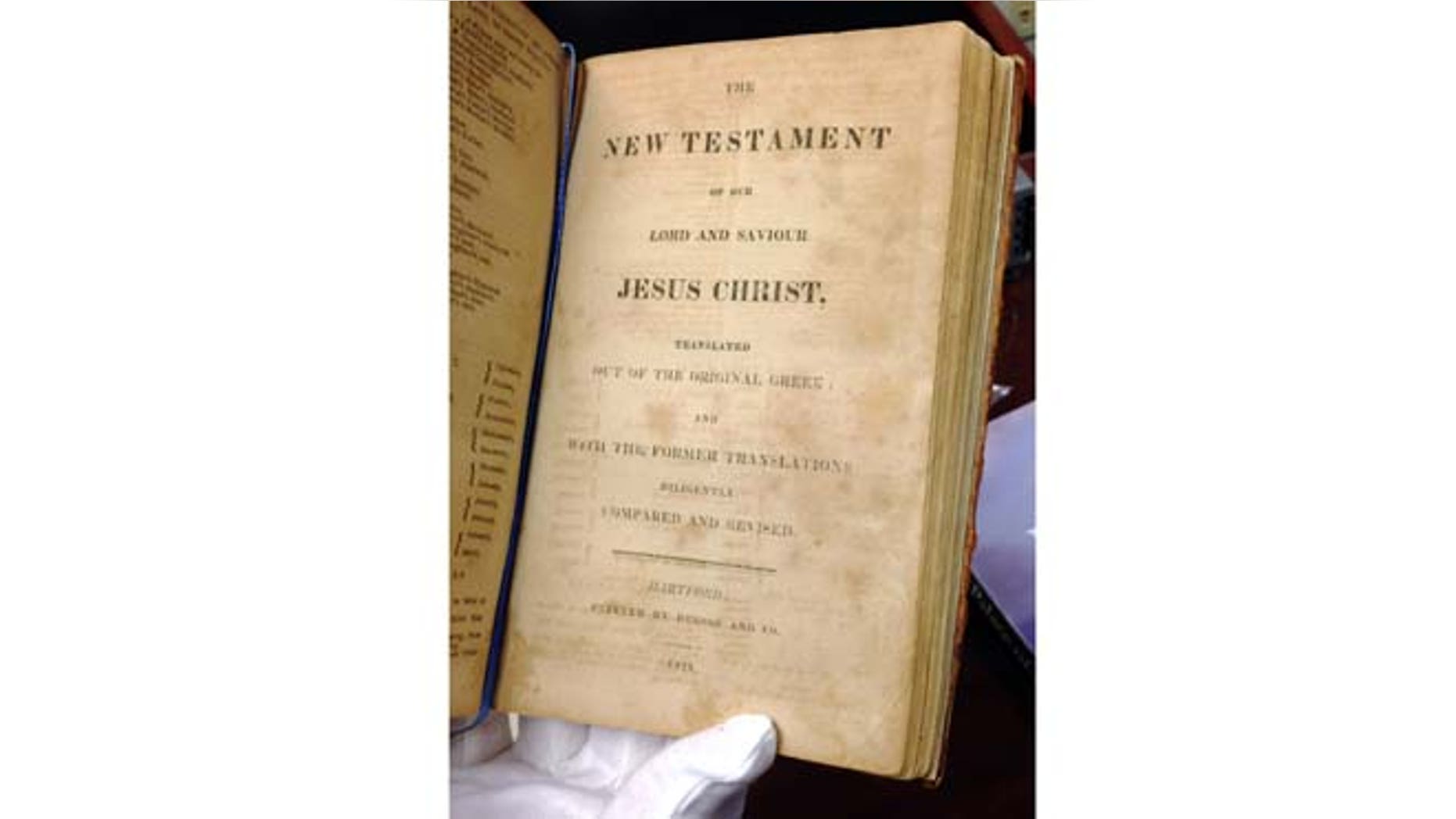 Jan. 12, 2015: In this photo, Texas Supreme Court archivist Tiffany Shopshire shows the 1816 publishing date at the bottom of a page in the Sam Houston Bible, in Austin, Texas. (AP)