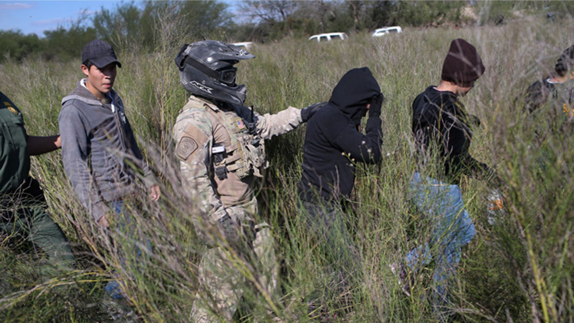A Border Patrol agent leads undocumented immigrants on December 7, 2015 near Rio Grande City, Texas.