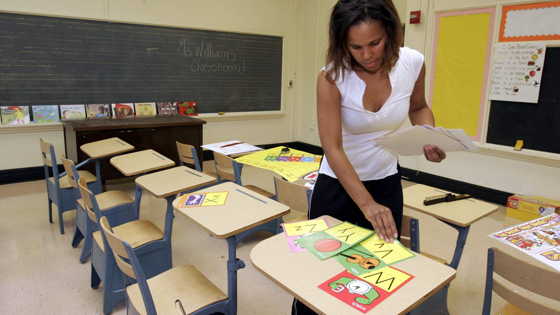 Ckaris Williams, a teacher and Hurricane Katrina evacuee, prepares her classroom at Douglass Elementary School in Houston September 7, 2005 in Houston,(Photo by Dave Einsel/Getty Images)