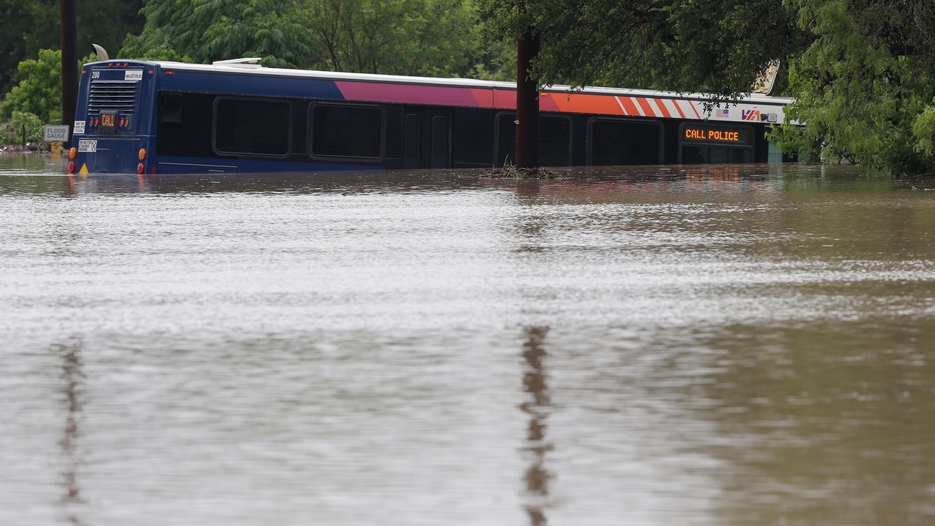 May 25, 2013: A San Antonio metro bus sits in floodwaters after it was swept off the road during heavy rains in San Antonio.