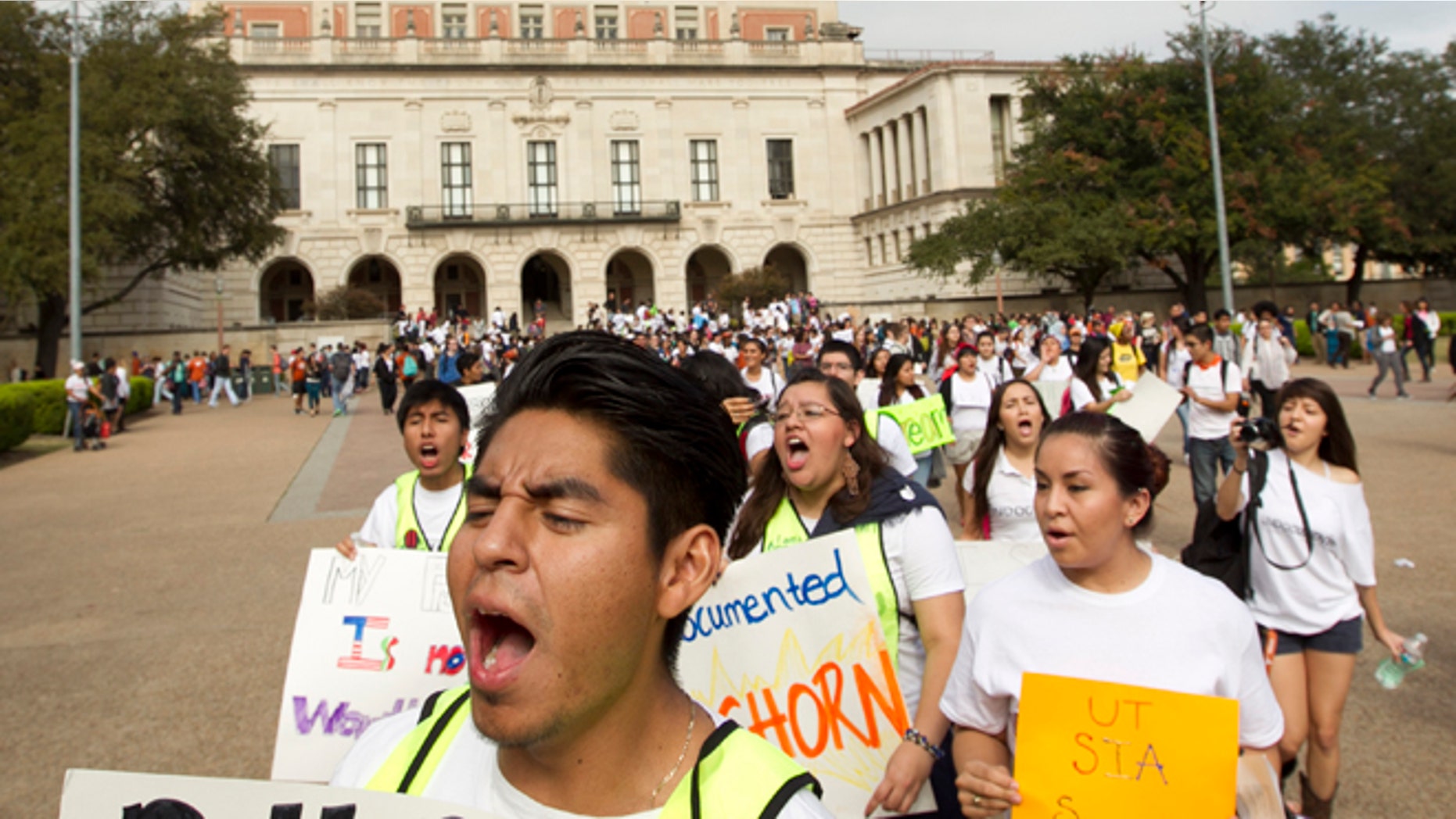 University of Texas student Jonathan Hernandez, 21, marches in an immigration rights rally on the University of Texas campus in Austin, Texas, Wednesday Nov. 20, 2013. The rally was organized in reaction to the student group Young Conservatives of Texas "Catch an Illegal Immigrant Game" that was canceled due to public outrage. (AP Photo/Austin American-Statesman, Jay Janner) AUSTIN CHRONICLE OUT, COMMUNITY IMPACT OUT, MAGS OUT; INTERNET AND TV MUST CREDIT PHOTOGRAPHER AND STATESMAN.COM