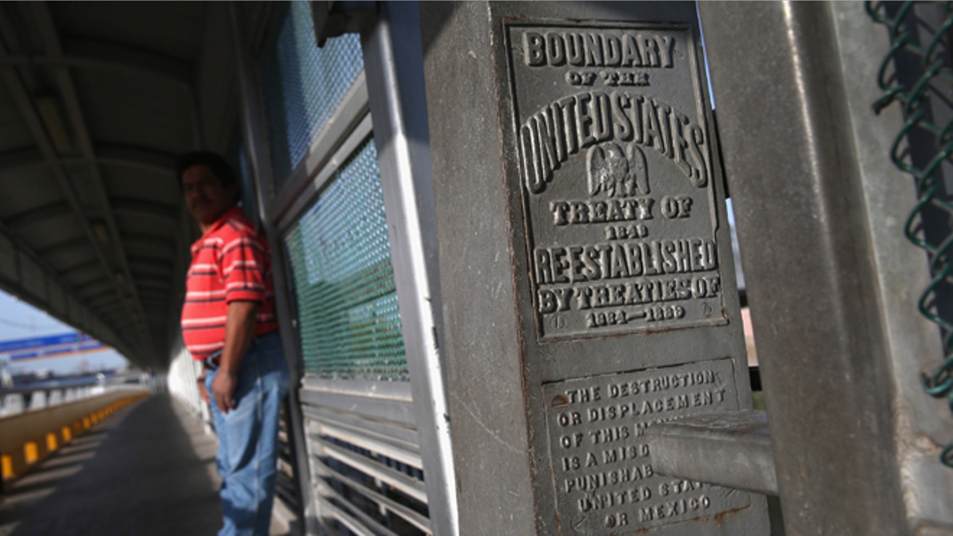 A marker over the Rio Grande River notes the border between the United States and Mexico (L), on April 11, 2013 in Hidalgo, Texas. A(Photo by John Moore/Getty Images)