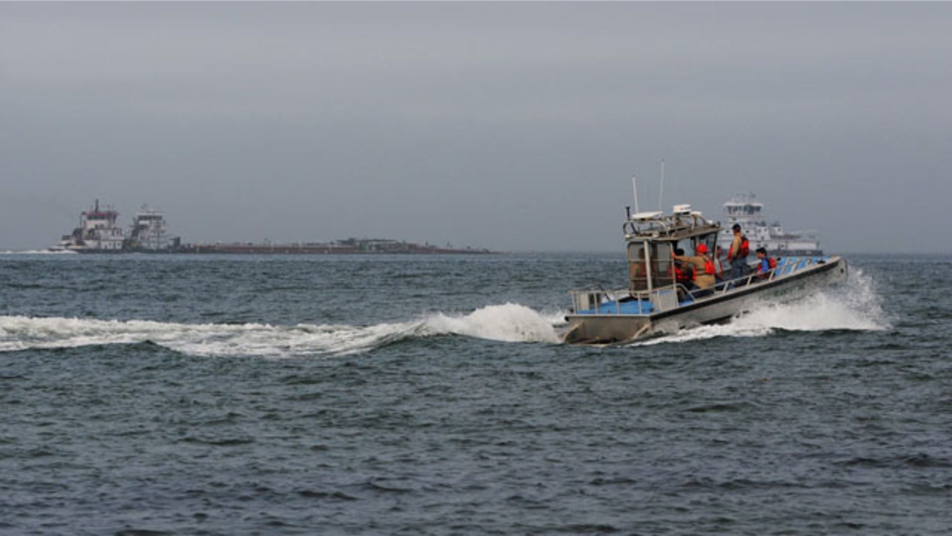 March 22, 2014: A response boat heads to the scene of a collision between a ship and barge in the ship channel near the Texas City Dike. Two workers on one of the vessels were exposed to hydrogen sulfide and decontaminated by the first department at the end of the dike. (AP Photo/The Galveston County Daily News, Neal Mora)
