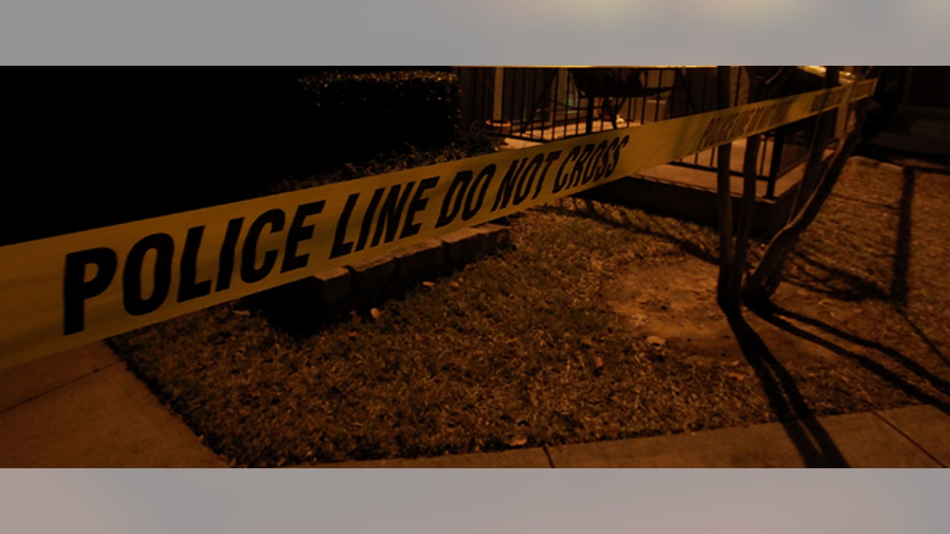 GRAPEVINE, TX - DECEMBER 25: Police line tape surrounds an apartment building where seven people were found dead at Lincoln Vineyard Apartment Homes on December 25, 2011 in Grapevine, Texas. (Photo by Ronald Martinez/Getty Images)
