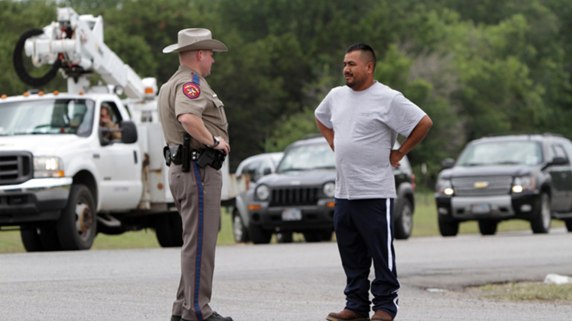 Pablo Ramirez, 33, right, speaks to a Texas state trooper on May 16, 2013 in Granbury, Texas.