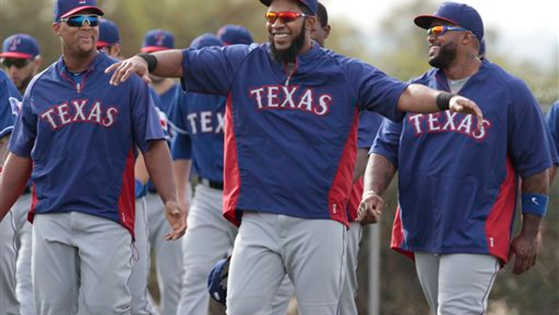 Texas Rangers infielders Adrian Beltre, left, and Prince Fielder, right, are entertained by Elvis Andrus during warm ups at baseball spring training camp in Surprise, Ariz., on Friday, Feb. 21, 2014. (AP Photo/The Fort Worth Star-Telegram, Ron T. Ennis) MAGS OUT; (FORT WORTH WEEKLY, 360 WEST); INTERNET OUT