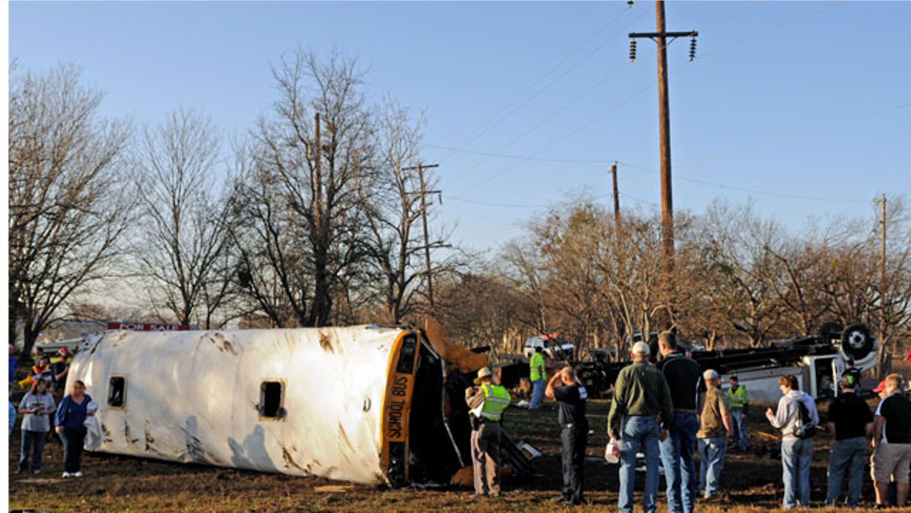 January 17, 2012: Emergency personnel investigate the scene of a wreck where a tractor-trailer clipped a school bus full of students, flipping the bus onto its side and sending 32 people — 29 of them children — to a central Texas hospital in Temple, Texas.