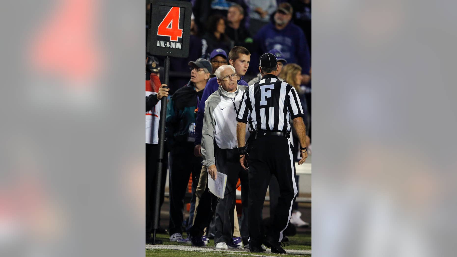 Kansas State head coach Bill Snyder looks around field judge Randy Smith to check ball placement during the second half of an NCAA college football game against Texas Tech in Manhattan, Kan., Saturday, Oct. 4, 2014. Kansas State defeated Texas Tech 45-13. (AP Photo/Orlin Wagner)