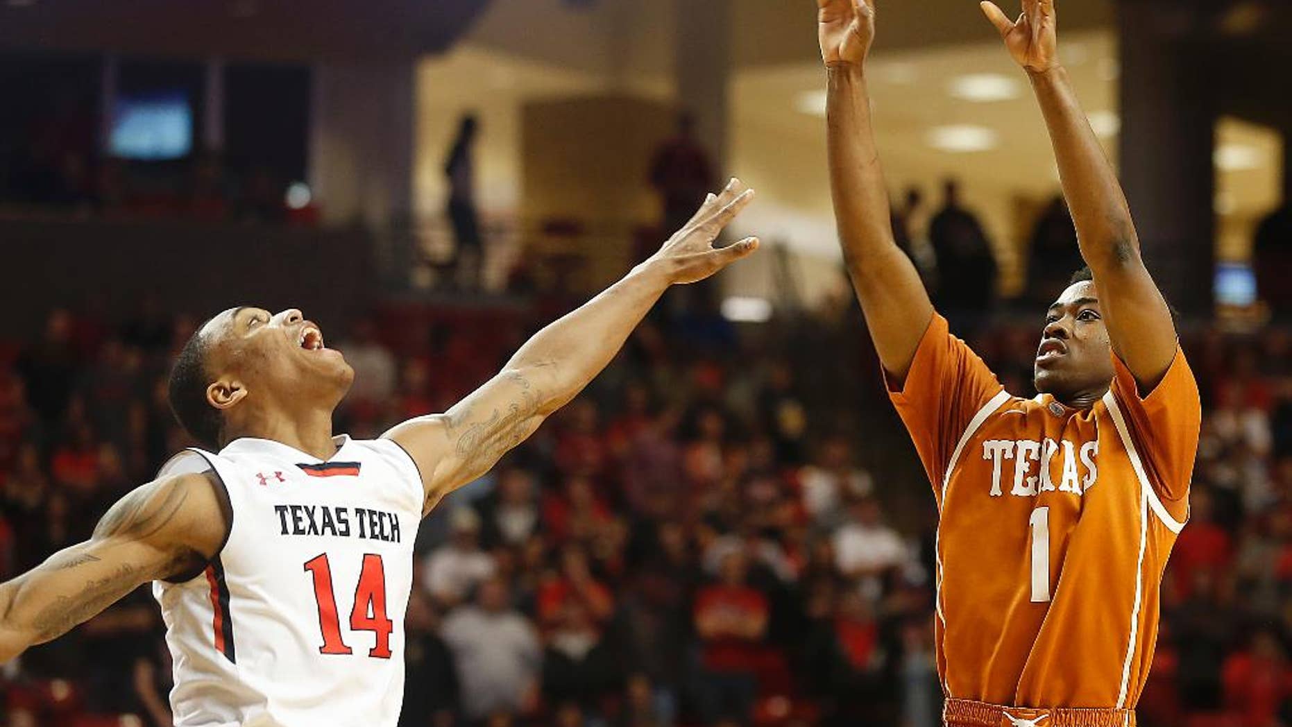 Texas' Isaiah Taylor shoots over Texas Tech's Robert Turner during their NCAA college basketball game in Lubbock, Texas, Saturday, Mar, 8, 2014. (AP Photo/Lubbock Avalanche-Journal, Zach Long) ALL LOCAL TV OUT