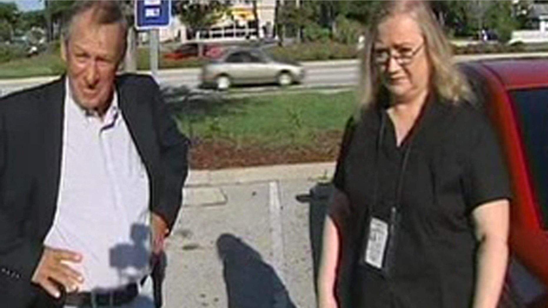 Tim Miller from Texas Equusearch, left, with Bonnie Moore from Process Express outside the Orange County jail Wednesday morning after serving Casey Anthony with a lawsuit.