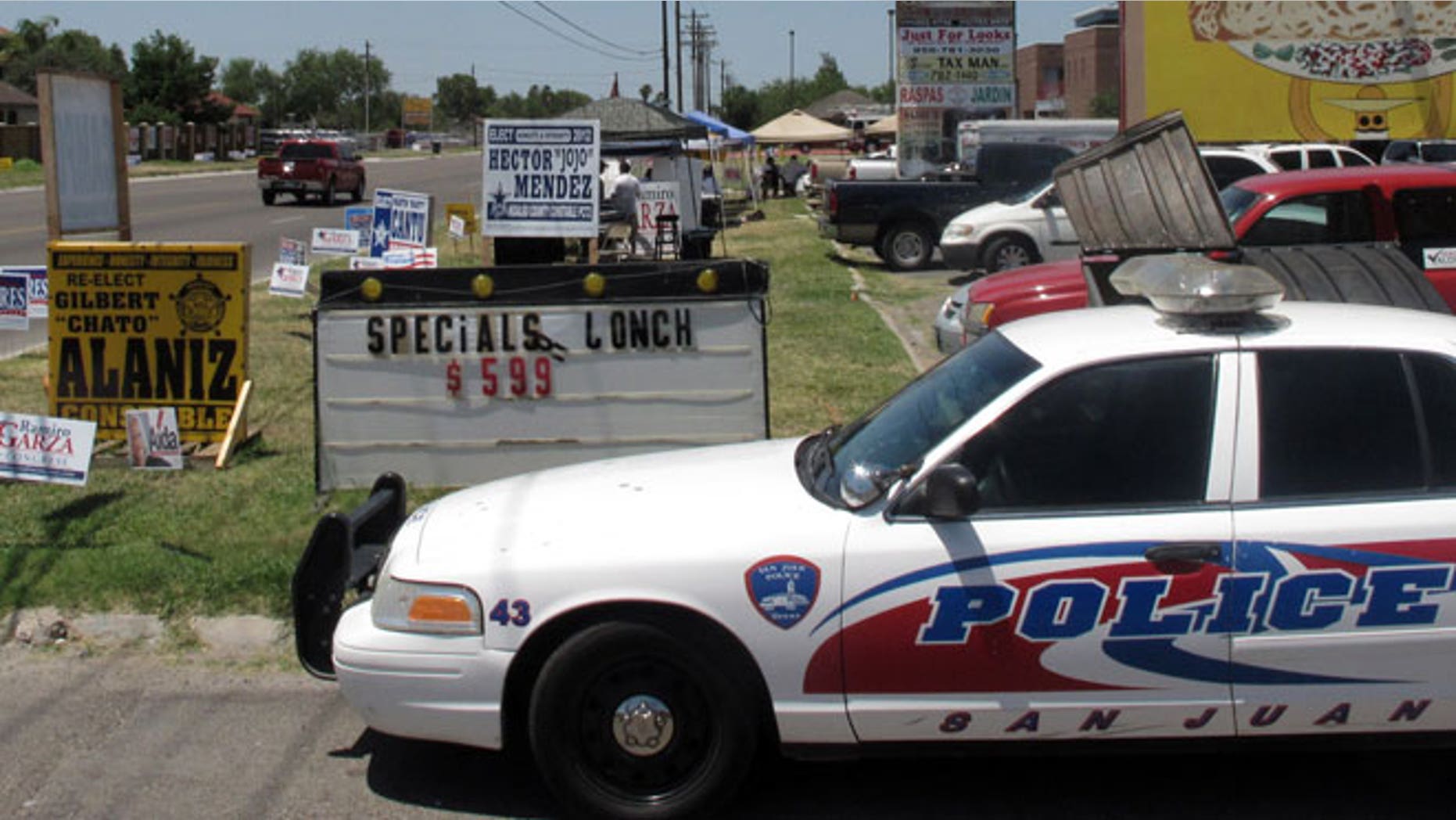 May 29, 2012: Police remain on a busy corner in San Juan, Texas where one man holding a campaign sign was shot in the leg by someone in a passing vehicle.