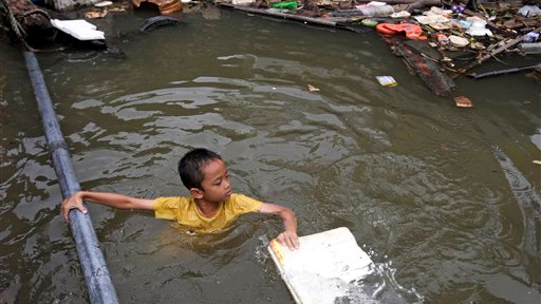 October 3: A Thai boy in a flooded area in Bangkok. Hundreds of people have died across Southeast Asia, China, Japan and South Asia in the last four months from prolonged monsoon flooding, typhoons and storms. The Thailand government said heavy floods have killed over 200 people since August.