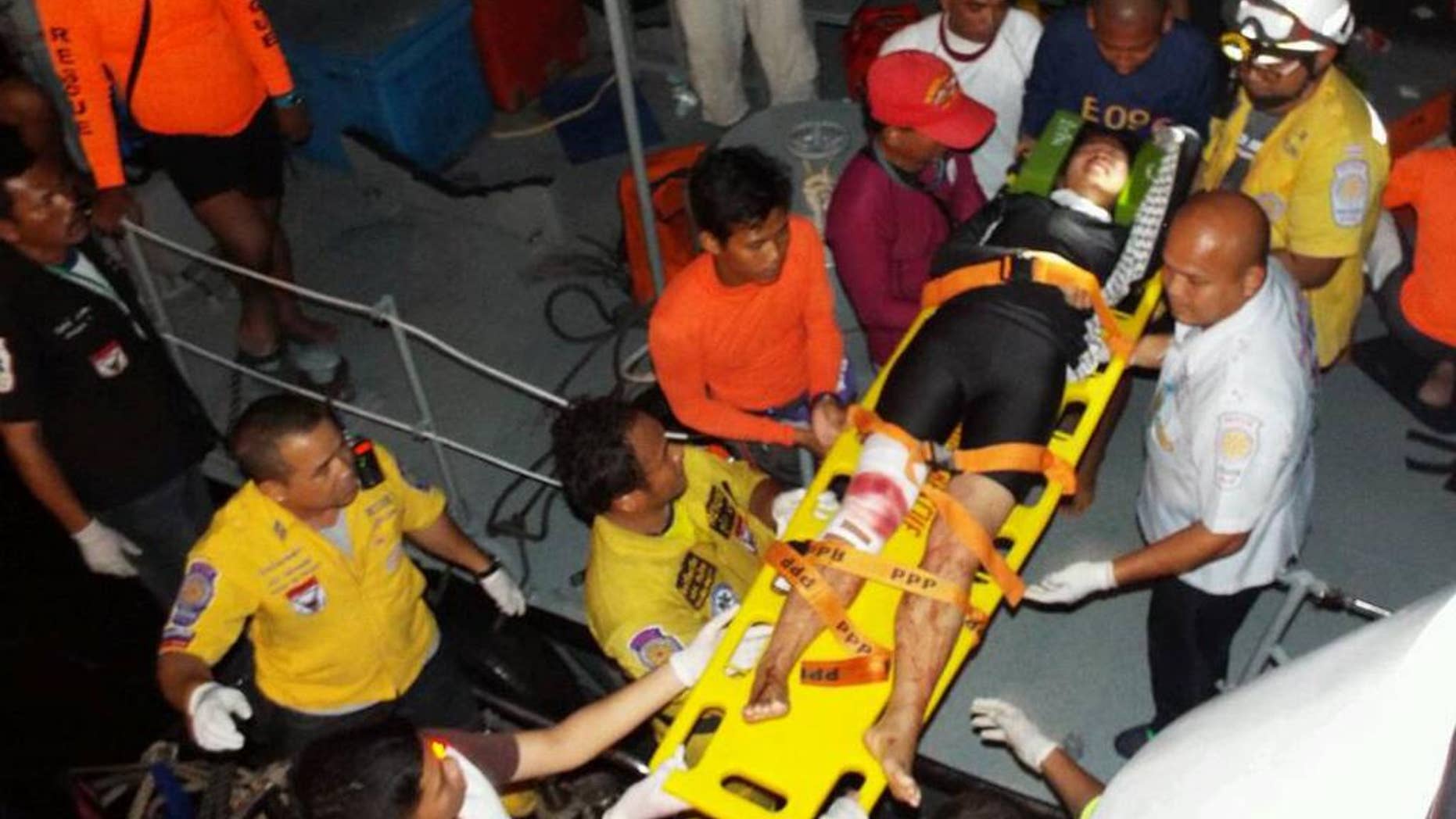Thai rescue workers move a injured tourist on stretcher to hospital after a fishing boat crashed with a speed boat, carrying tourists from Koh Phi Phi island to a pier in Phuket. Thailand Sunday Oct. 19, 2014. 27 tourists injured and two are missing.(AP Photo) THAILAND OUT