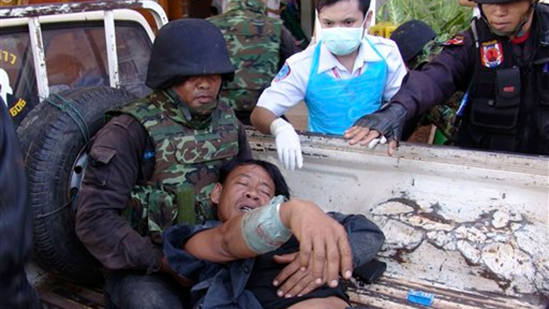 April 22: A Thai soldier injured in a fighting with Cambodia is helped by his comrades and a nurse after arriving at a hospital in Phnom Dongrak district of Surin province, northeastern Thailand. Thailand and Cambodia exchanged artillery and gunfire for several hours along their disputed frontier Friday in a new flare-up of their long-running conflict. It was the first skirmish reported since the two Southeast Asian countries battled for four straight days in February at the 11th century Preah Vihear temple. (AP)