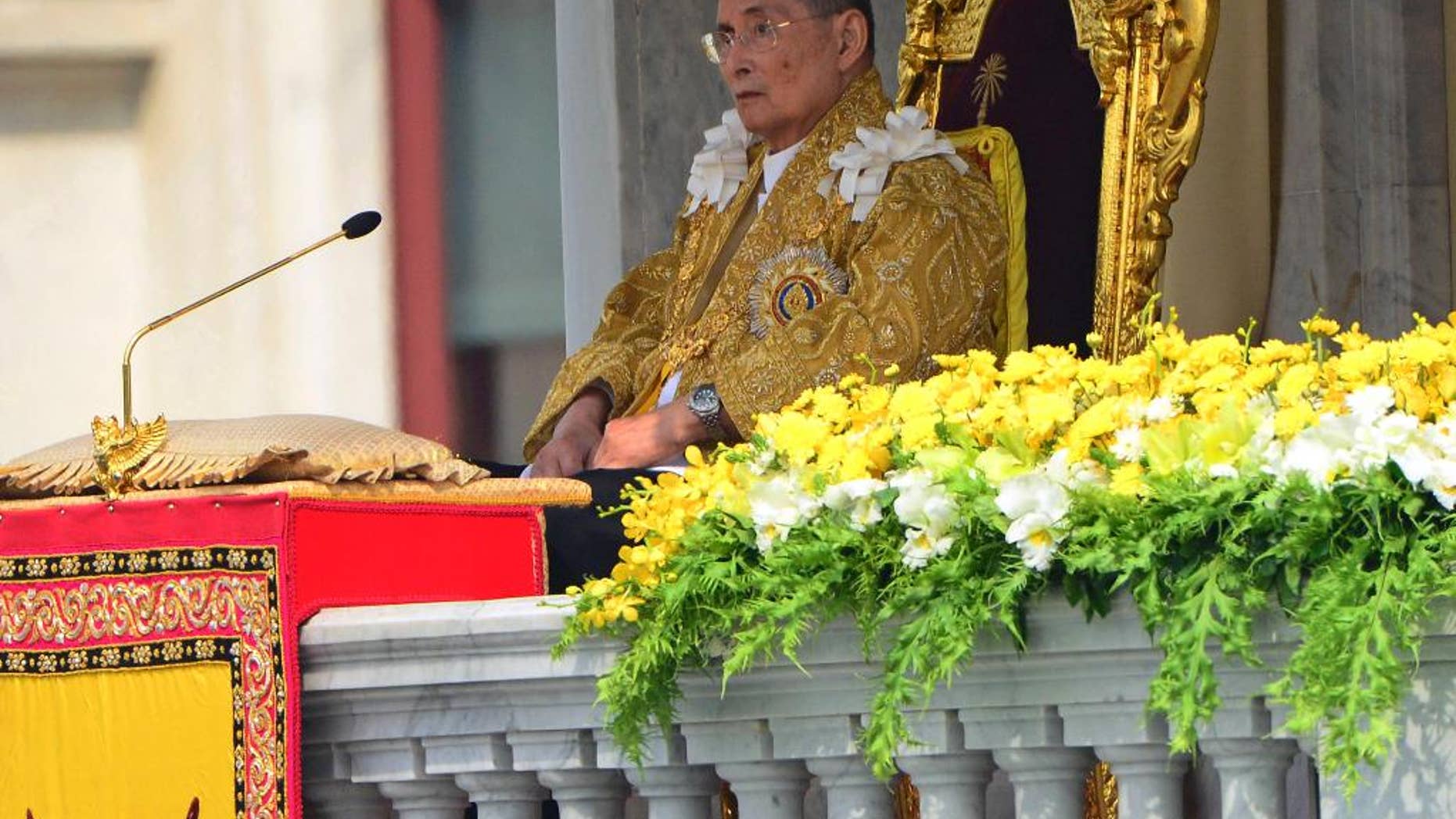 FILE - In this Dec. 5, 2012 file photo, Thai King Bhumibol Adulyadej appears to address a crowd from the balcony at the Anantha Samakhom Throne Hall in Bangkok, Thailand, during his 85th birthday celebration. Thailand's royal palace said in a statement that doctors reported Monday, Sept. 28, 2015, that a blood test and a chest X-ray of King Bhumibol Adulyadej showed that infections detected in early September had cleared up. It said the king's pulse, blood pressure, breathing, blood oxygen level and body temperature were normal.(AP Photo/Sakchai Lalit, File)