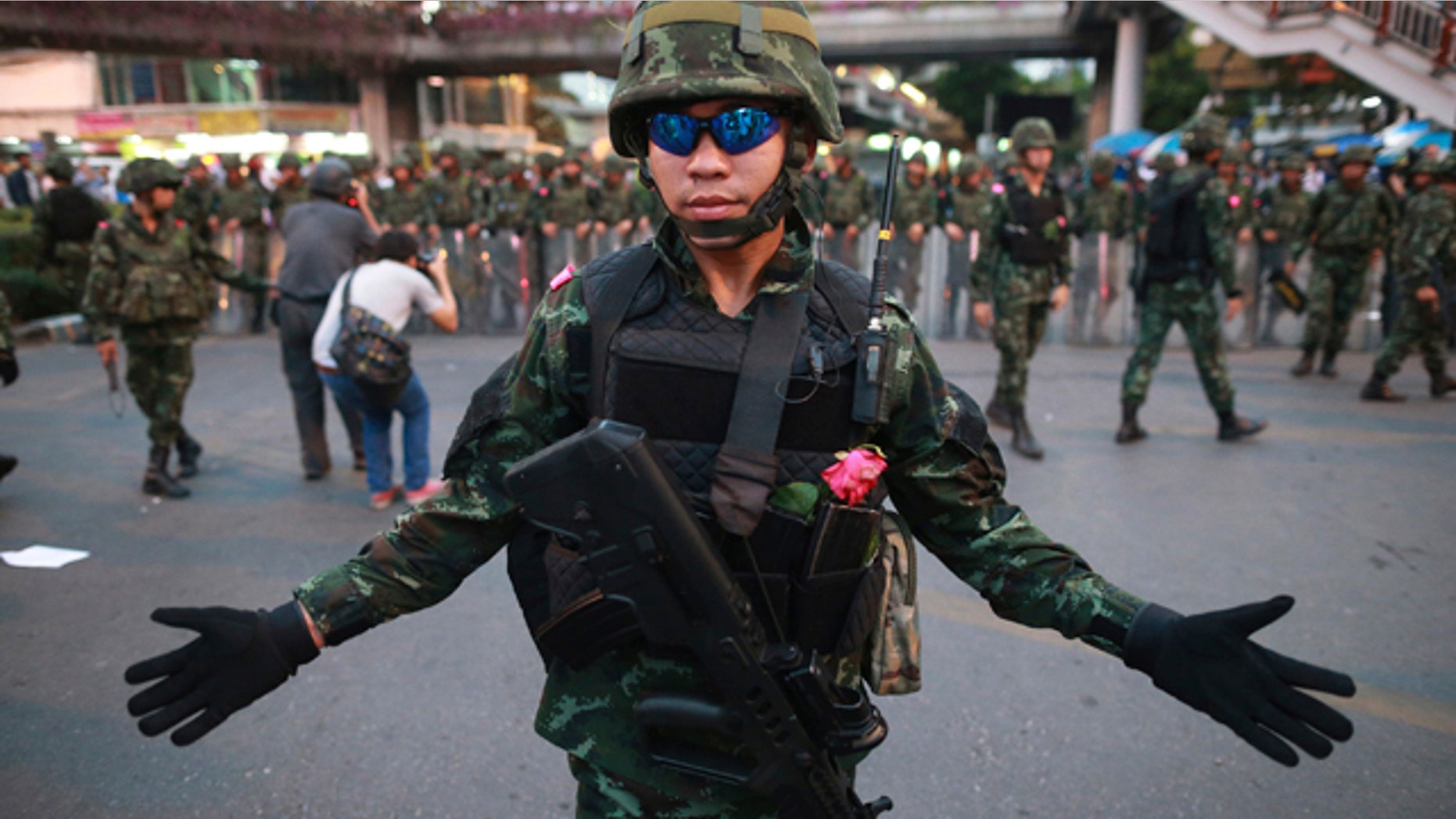 May 26, 2014: A Thai soldier gestures as he and his colleagues guard the Victory Monument during an anti-coup demonstration in Bangkok.(AP Photo/Wason Wanichakorn)