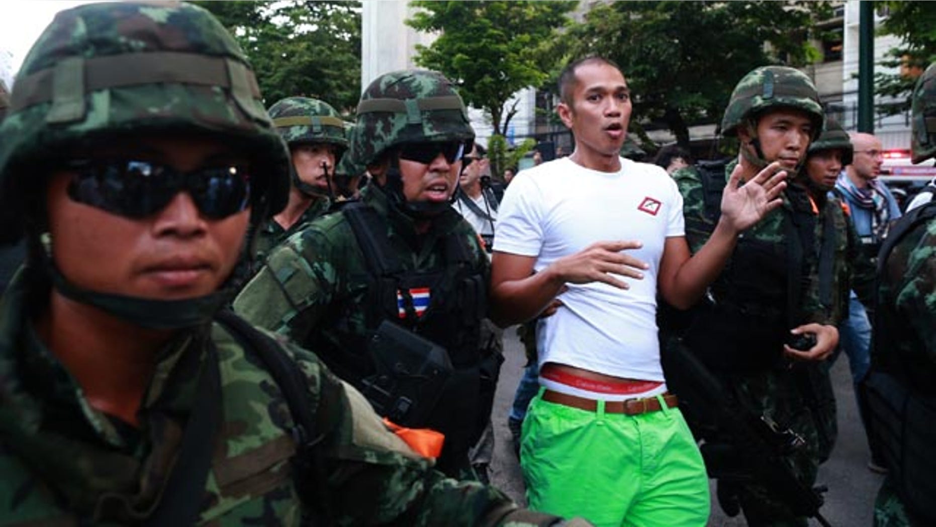 May 24, 2014: A protester is detained by Thai soldiers during an anti-coup demonstration at the Victory Monument in Bangkok. (AP Photo/Wason Wanichakorn)