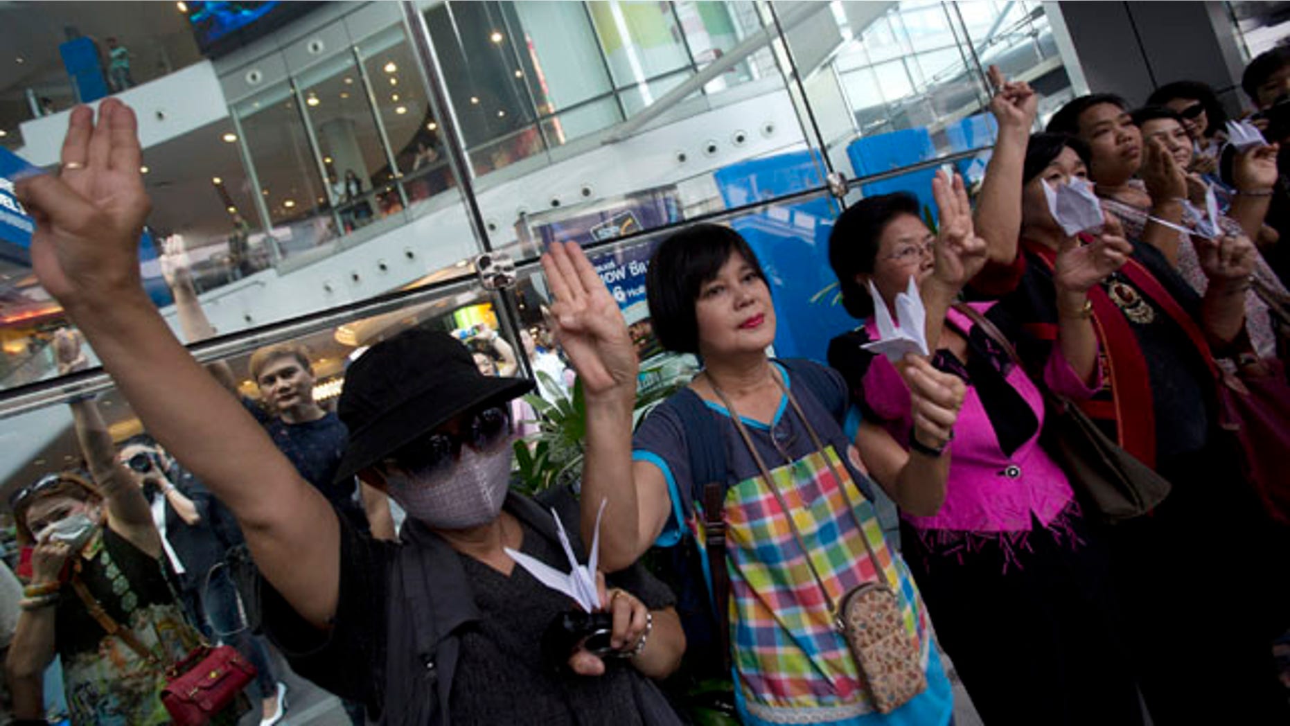 June 1, 2014: Protesters show three fingers represent liberty, brotherhood and equality during an anti-coup demonstration in Bangkok, Thailand. (AP Photo/Sakchai Lalit)