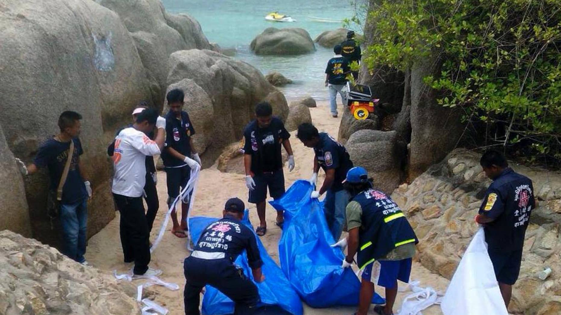 The body of slain British tourist, David Miller, wrapped in plastic sheet, is carried at a forensic police facility in Bangkok, Thailand, Tuesday, Sept. 16, 2014. Police on the scenic resort island of Koh Tao in southern Thailand conducted a sweep of hotels and workers' residences Tuesday searching for clues into the slayings of two British tourists whose nearly naked, battered bodies were found on a beach a day earlier.(AP Photo/Sakchai Lalit)