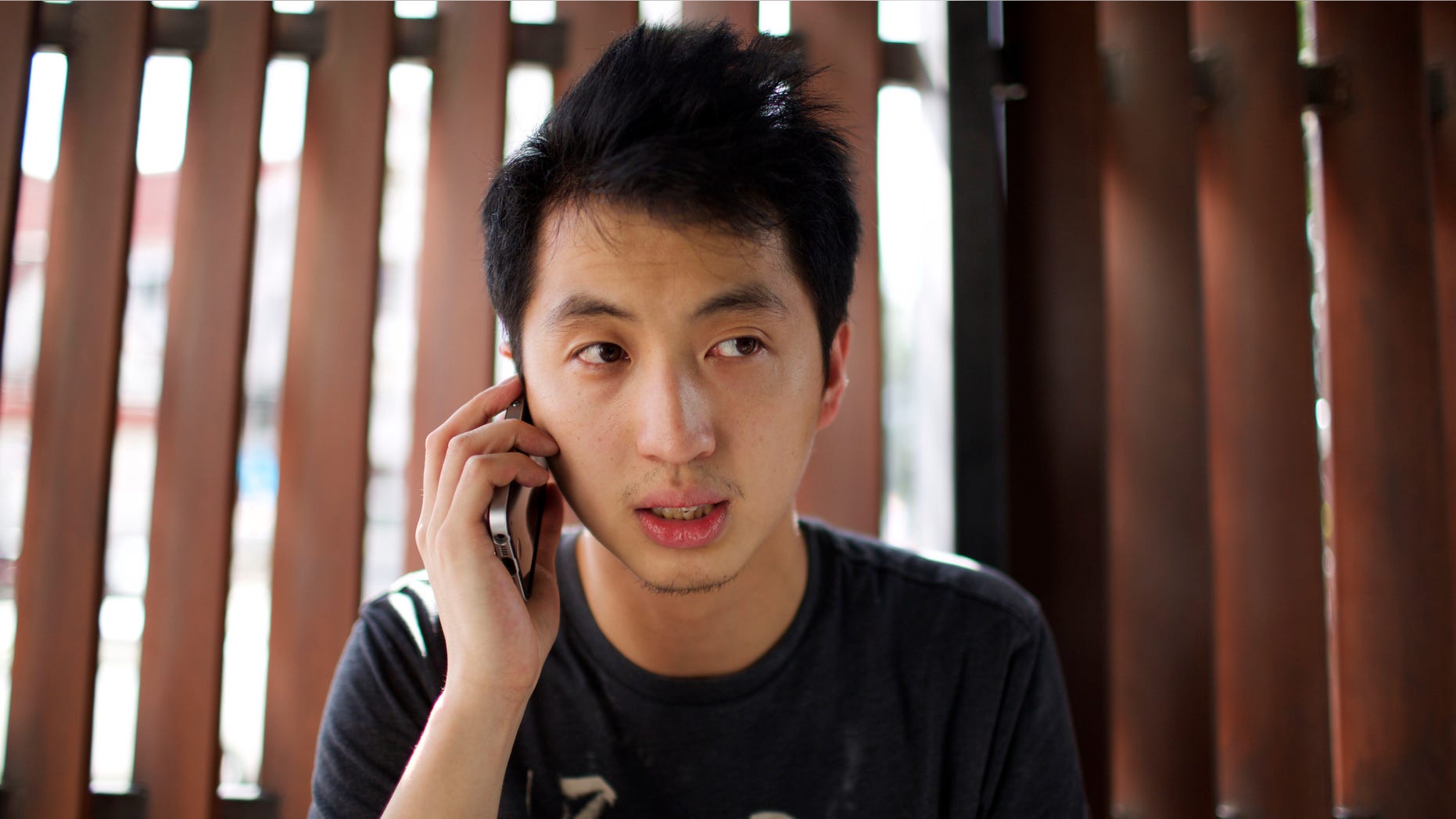 Aug. 24, 2015- FILE photo of Hong Kong photojournalist Hok Chun Anthony Kwan after leaving Samut Prakan provincial court on bail, following his arrest on Aug. 23 at Suvarnabhumi Airport in Bangkok, Thailand. A Thai court decided to put Kwan on trial for possession of a bulletproof vest and a helmet, which are considered weapons in Thailand.
