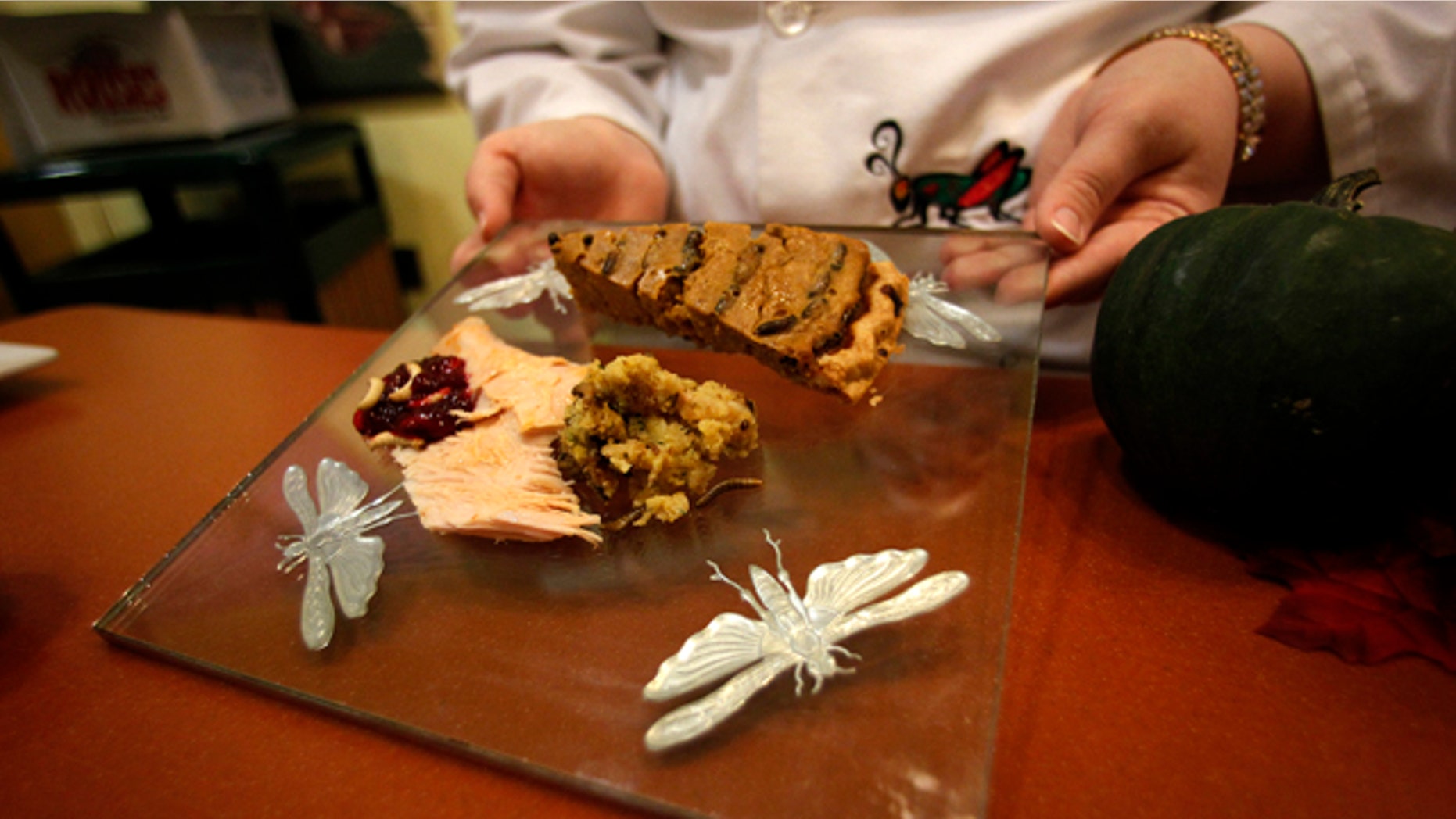 Nov. 11, 2011: Stephanie Smith, an educator at the Audubon Insectarium in New Orleans, shows off a plate of cranberry sauce with wax worms, cricket pumpkin pie, and turkey with cornbread and mealworm stuffing, for visitors to sample Thanksgiving-inspired foods made with insects.