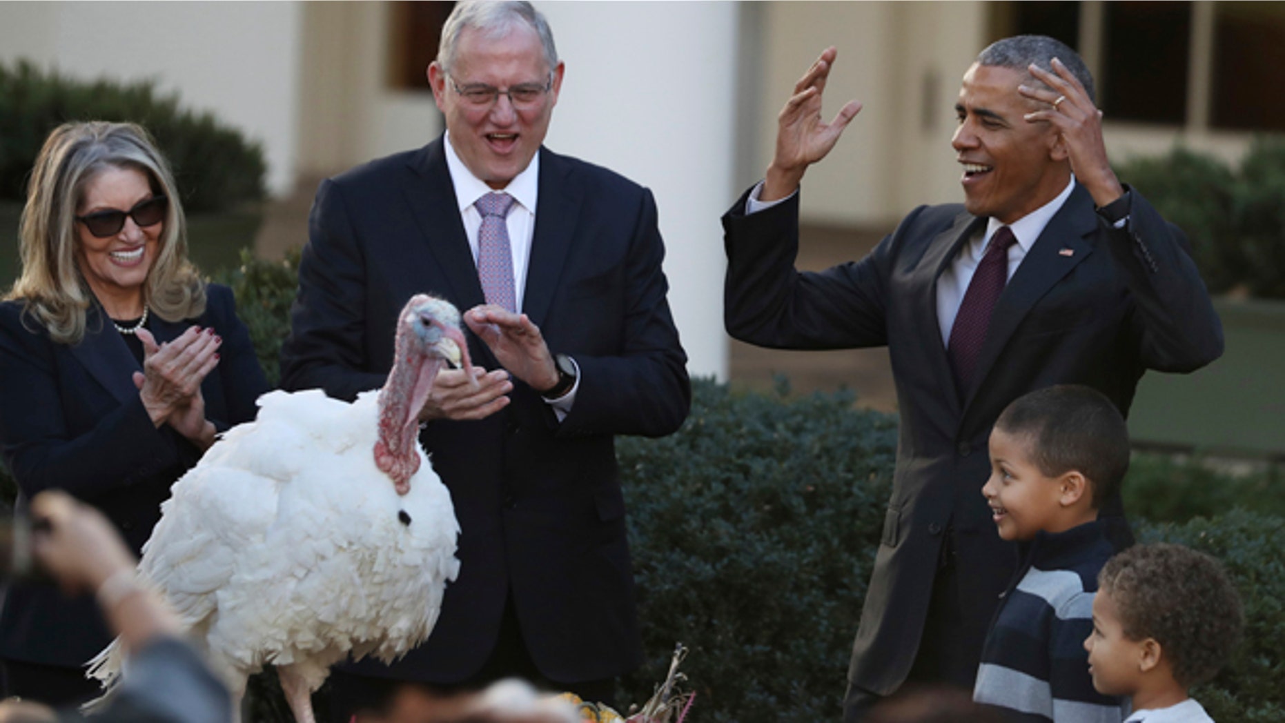 President Barack Obama, with his nephews Aaron Robinson and Austin Robinson, and National Turkey Federation Chairman John Reicks, pardons the National Thanksgiving Turkey, Tot, Wednesday, Nov. 23, 2016, during a ceremony in the Rose Garden of the White House in Washington. This is the 69th anniversary of the National Thanksgiving Turkey presentation. (AP Photo/Manuel Balce Ceneta)