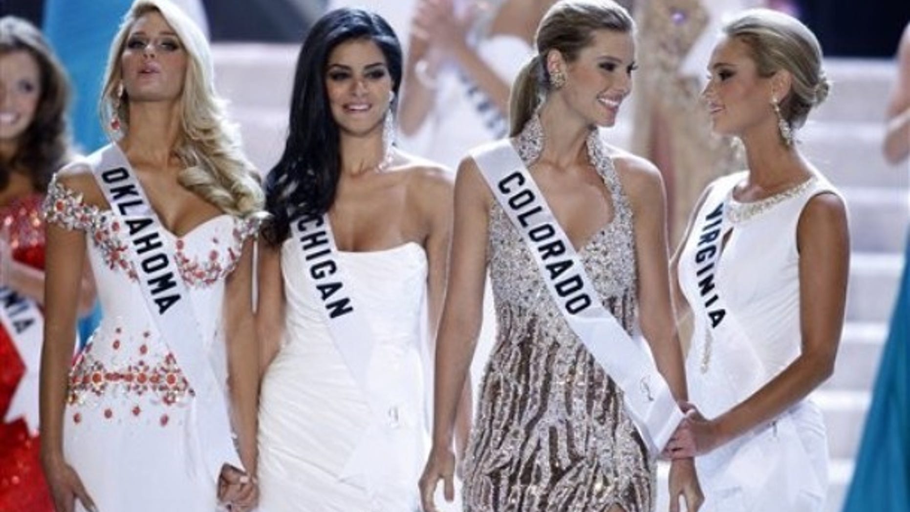 Finalists Morgan Elizabeth Woolard, left, Miss Michigan Rima Fakih, Miss Colorado Jessica Hartman and Miss Virginia Samantha Evelyn Casey react as Hartman is named third runner-up during the Miss USA 2010 pageant Sunday, May 16, 2010 in Las Vegas. Fakih was later crowned Miss USA. (AP Photo/Isaac Brekken)