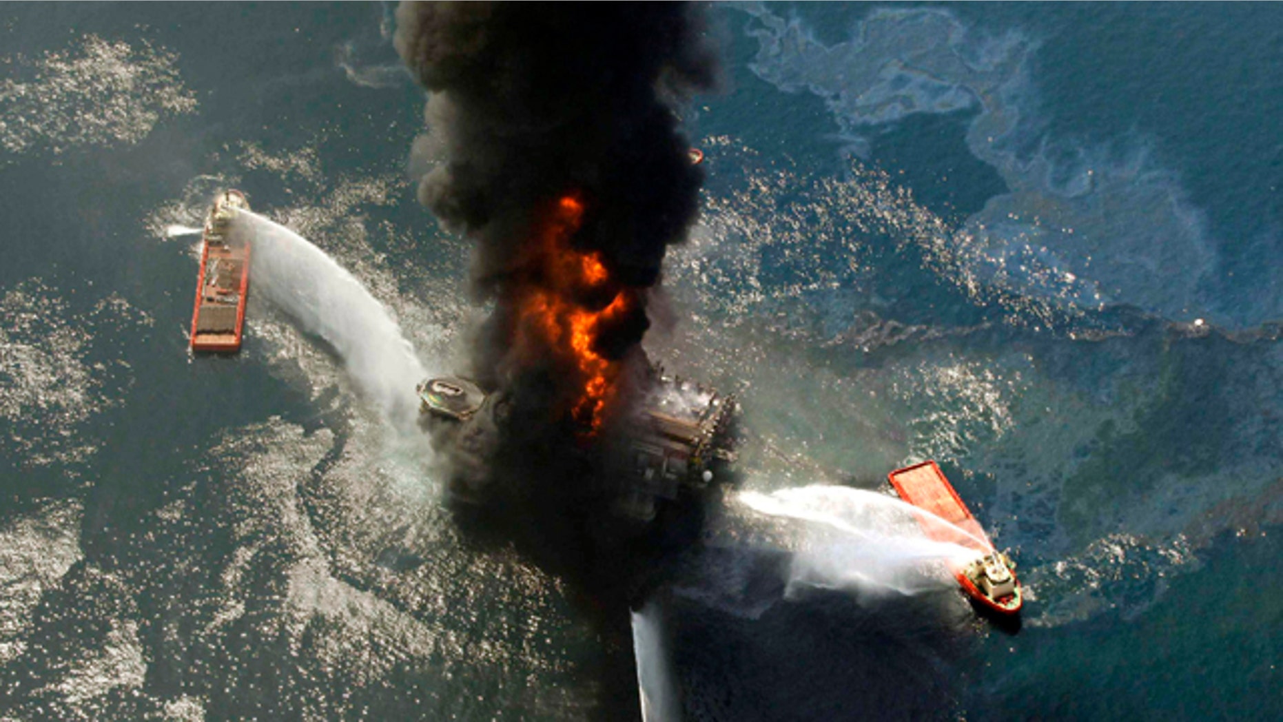 This April 21, 2010, file photo shows the Deepwater Horizon oil rig burning after an explosion in the Gulf of Mexico, off the southeast tip of Louisiana. A new study from the presidential oil spill commission describes the behind-the-scenes, excruiating tension and mistakes behind the three-month effort to cap the busted well.