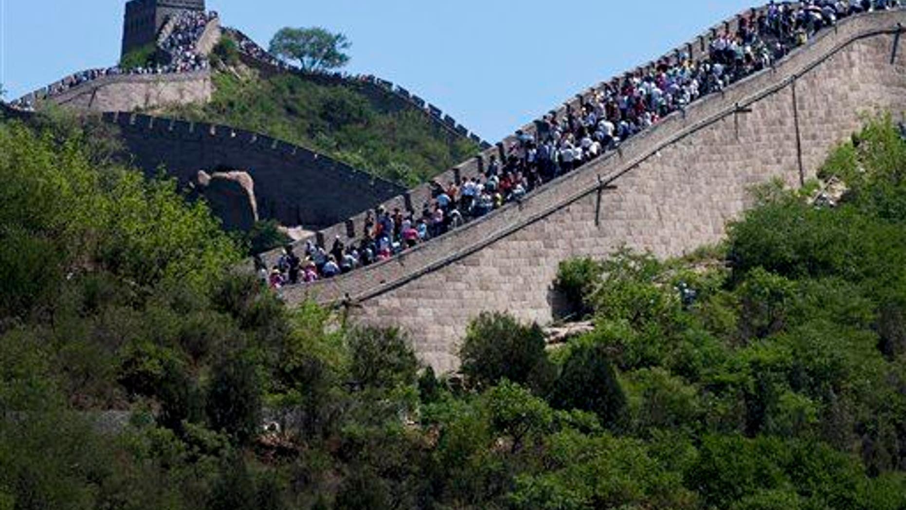 Tourists go sightseeing on the Great Wall of China during a weekend at Badaling, north of Beijing, June 2, 2012.