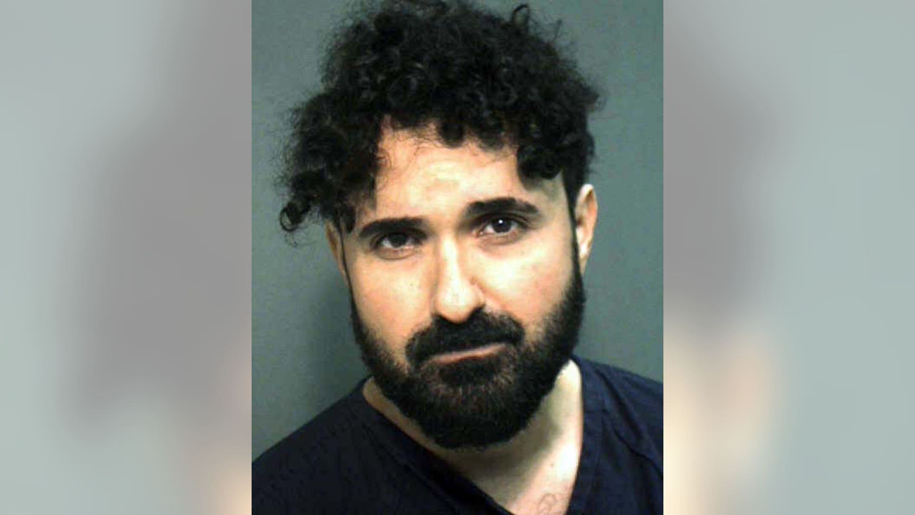 This arrest photo provided by the Orange County, Fla., Sheriff's Office, on Monday, Jan. 4, 2016, shows Frederick Torres. Torres, a recently fired caricature artist at Universal Orlando Resort, tried to kill his manager by stabbing him in the neck with scissors on New Year's Day at the Islands of Adventure park, according to a police report released Monday. (Orange County Sheriff's Office via AP)