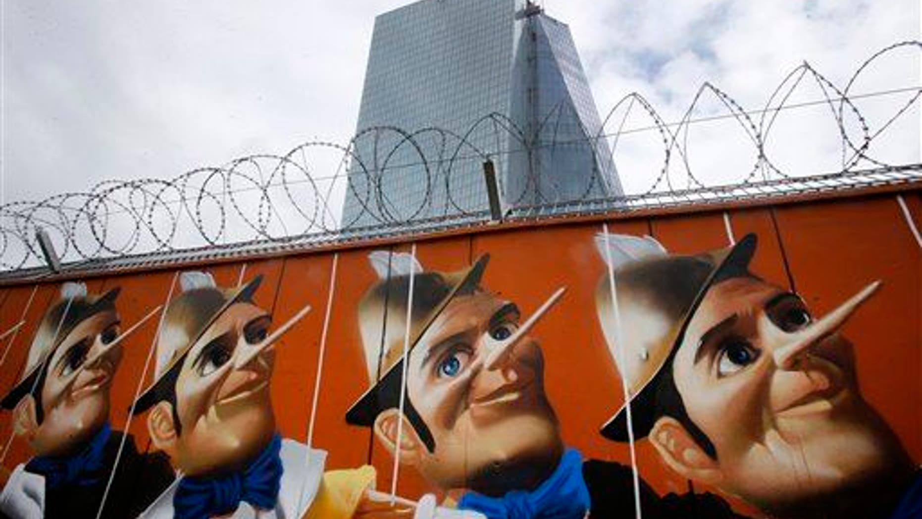 Graffiti is painted on a fence around the construction site of the new HQ of the European Central Bank. The graffiti was created by German street artist Case, who painted 16 Pinocchios.