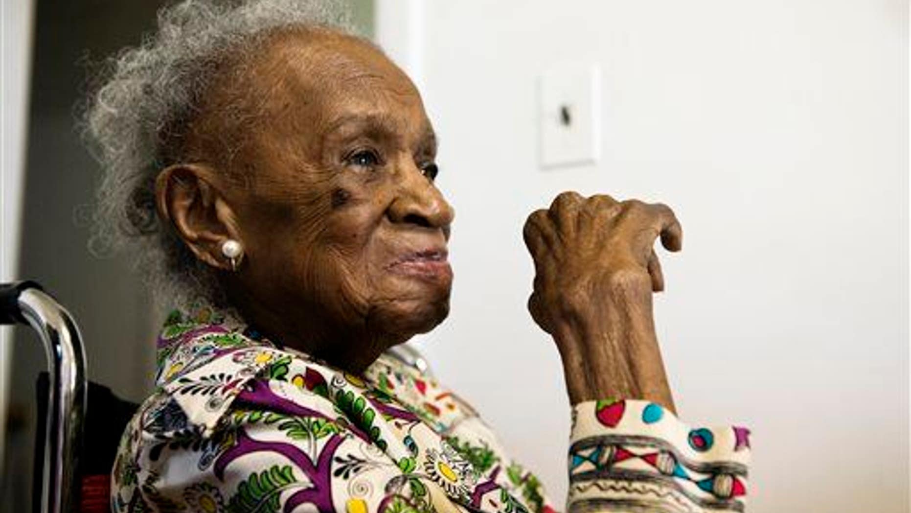 In this July 16, 2015, photo, Agnes Fenton looks on at her home in Englewood, NJ. Fenton turns 110 on Aug. 1."God and Johnnie Walker Blue are the keys to longevity," said Fenton.