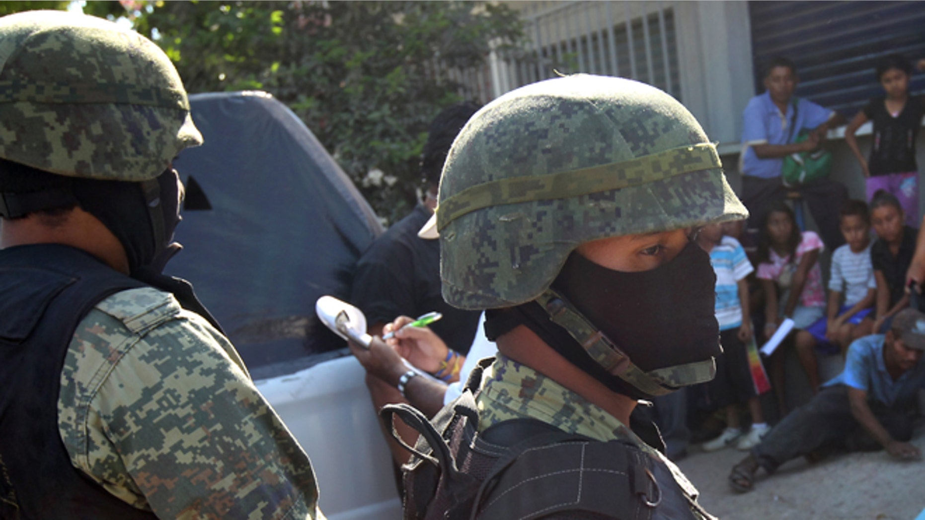 ACAPULCO, MEXICO - MARCH 03: Mexican marines stand guard at the site of a suspected drug-related execution on March 3, 2012 near Acapulco, Mexico. Drug violence has surged in the coastal resort in the last year, making Acapulco the second most deadly city in Mexico after Juarez. One of Mexico's top tourist destinations, Acapulco has suffered a drop in business, especially from foreign tourists, due to the violence. Toursim accounts for about 70 percent of the economy of Acapulco's state of Guerrero and 9 percent of Mexico's economy. (Photo by John Moore/Getty Images)