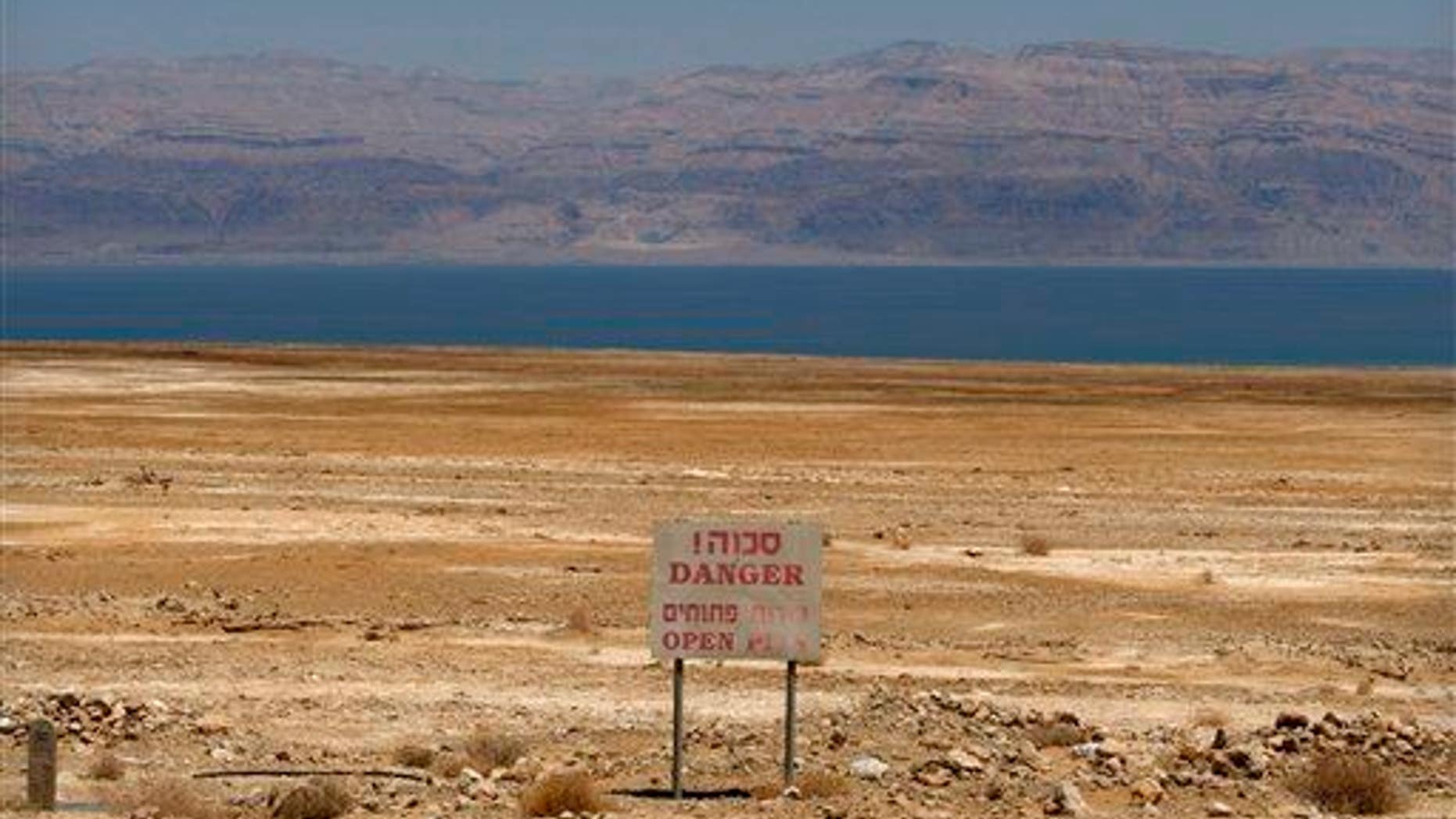 In this photo taken Thursday, May 28, 2009, a warning sign is seen near the Dead Sea coast.
