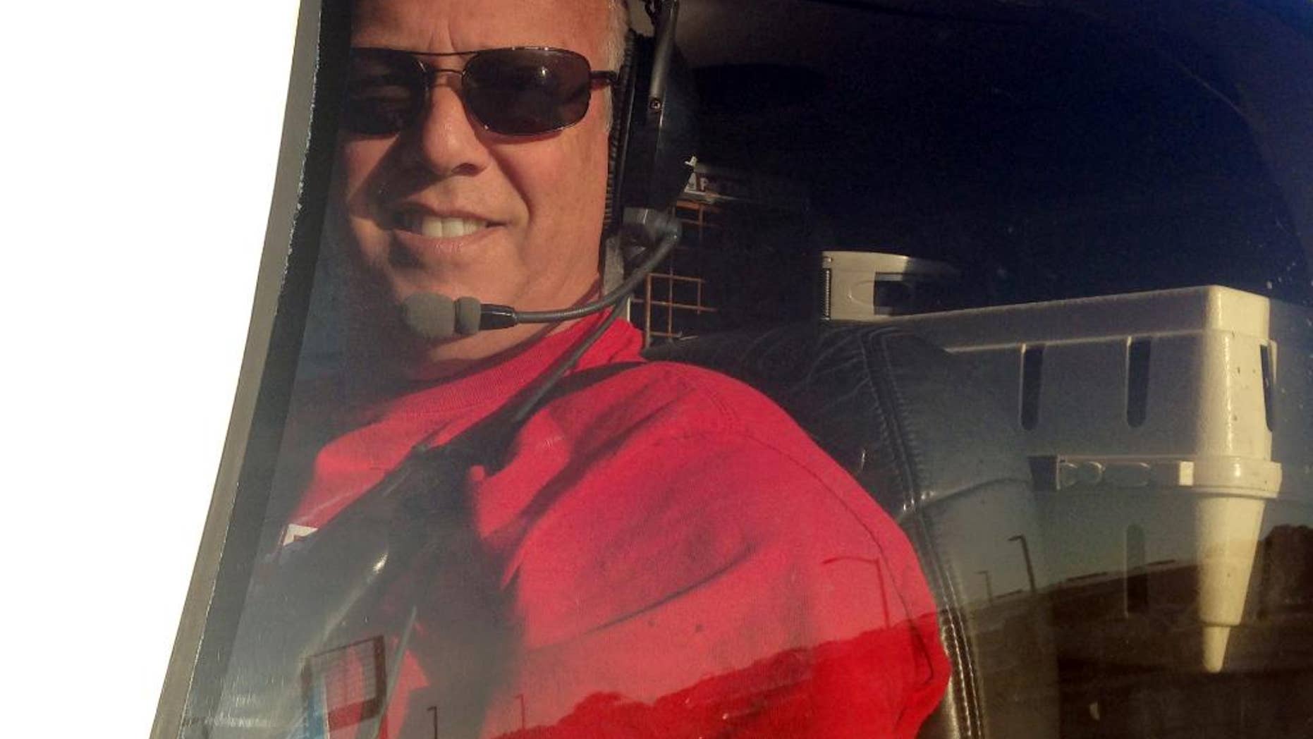 In this Dec. 10, 2014 photo, Jeff Bennett arrives with his 3,000th rescue animal to safety in Tampa, Fla. Bennett flew to the Florida Panhandle and picked up a French bulldog named Reggie, along with several other animals, from shelters and foster homes in Alabama. Bennett has been flying animals from overcrowded shelters to foster homes and vacant shelters for six years. (AP Photo/ Tamara Lush)