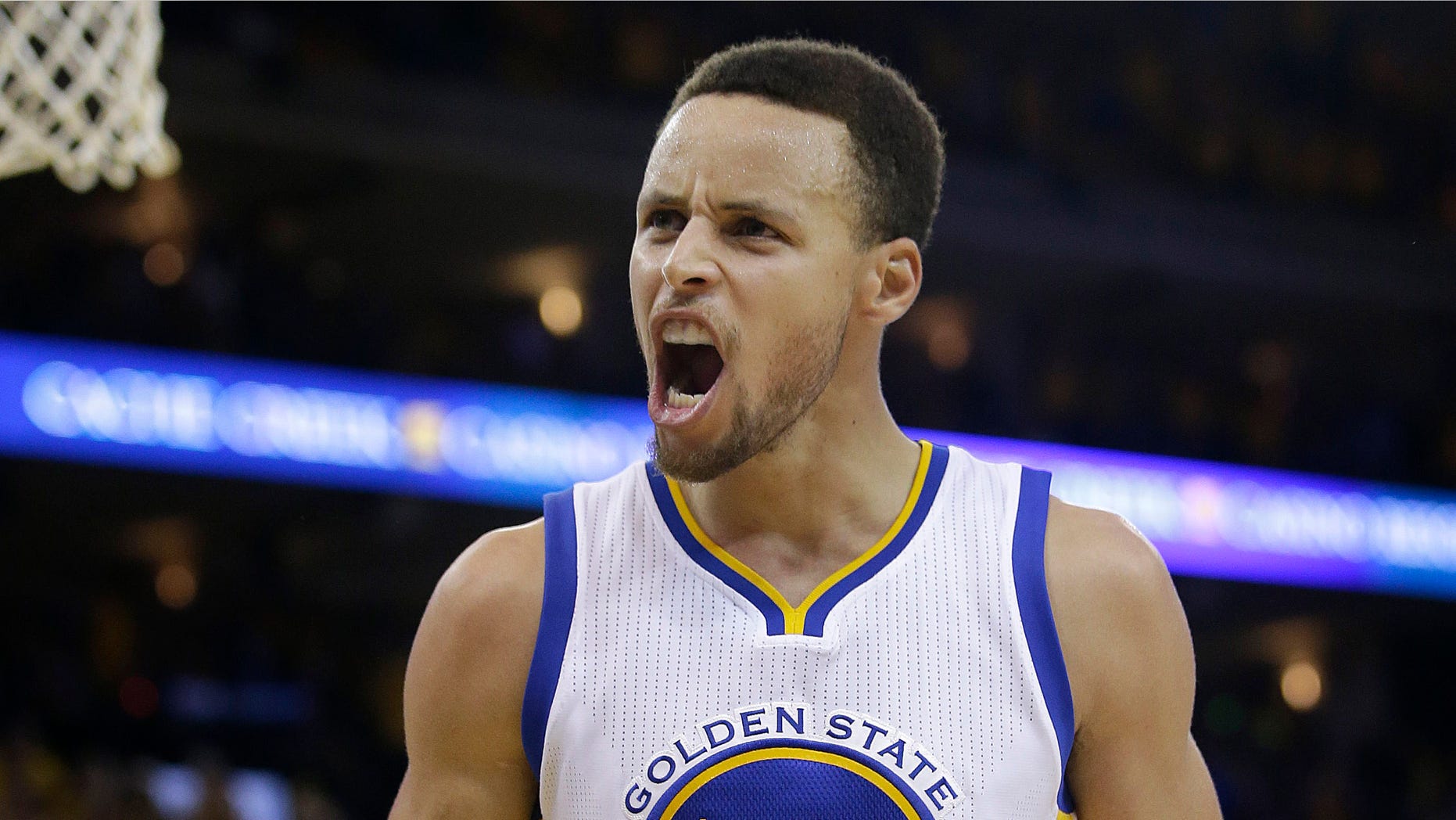 Golden State Warriors guard Stephen Curry (30) reacts after Shaun Livingston scored against the Oklahoma City Thunder during the second half of Game 7 of the NBA basketball Western Conference finals in Oakland, Calif., Monday, May 30, 2016. (AP Photo/Marcio Jose Sanchez)