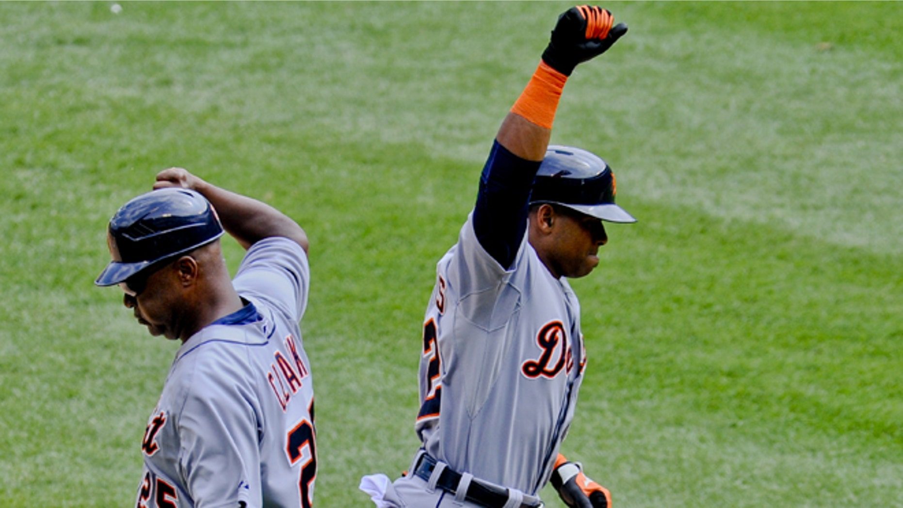 Detroit Tigers Yoenis Cespedes high-fives with coach Dave Clark in Chicago on Sunday, June 7, 2015.