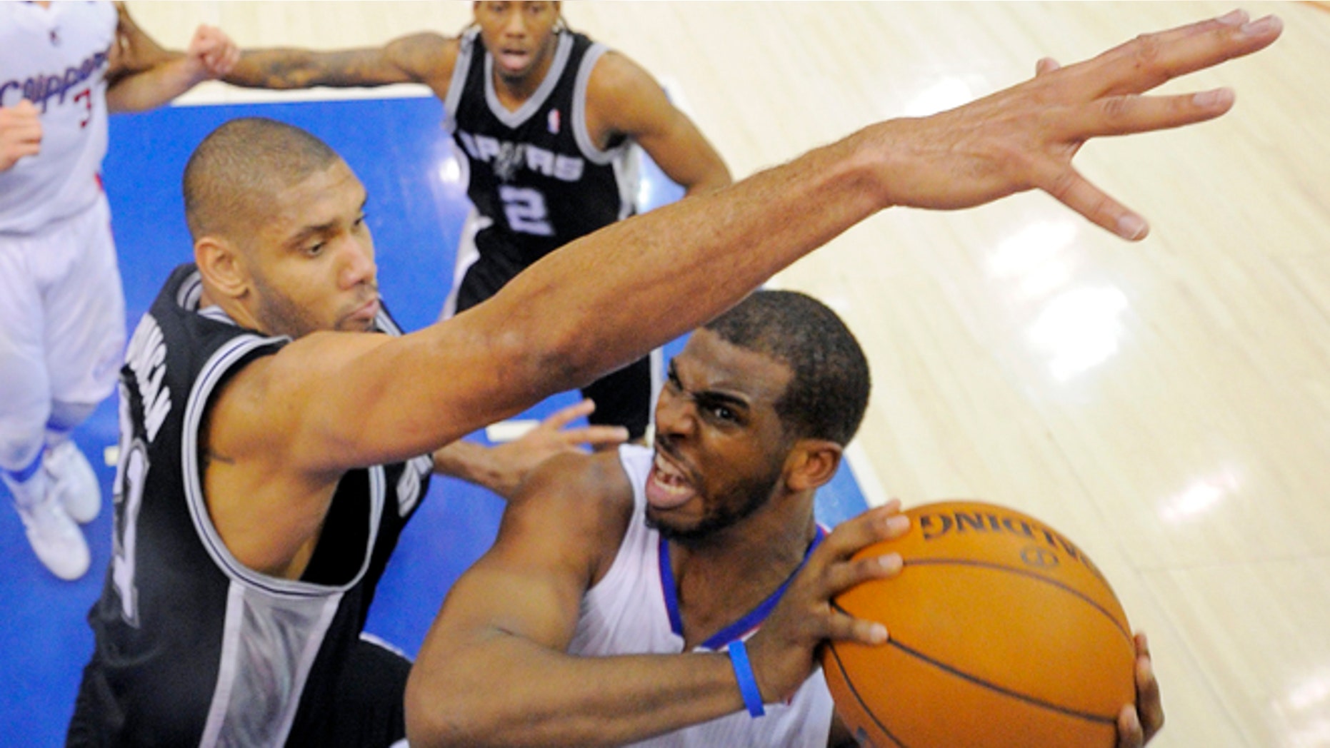 Los Angeles Clippers guard Chris Paul, right, puts up a shot as San Antonio Spurs center Tim Duncan defends during the second half in Game 4 of an NBA basketball playoffs Western Conference semifinal, Sunday, May 20, 2012, in Los Angeles. The Spurs won 102-99. (AP Photo/Mark J. Terrill)