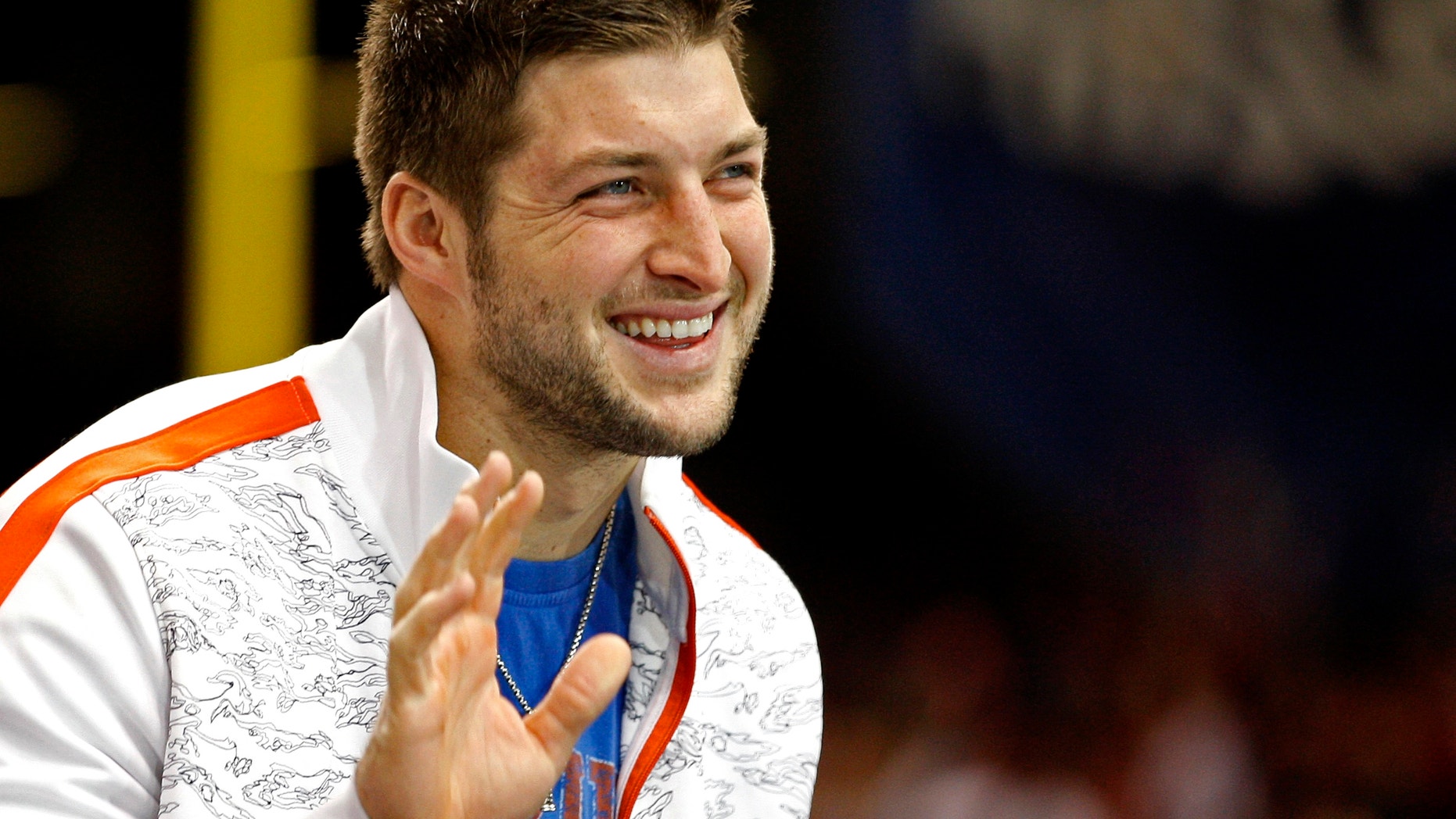 Former Florida Gators football star Tim Tebow waves to a crowd of fans.