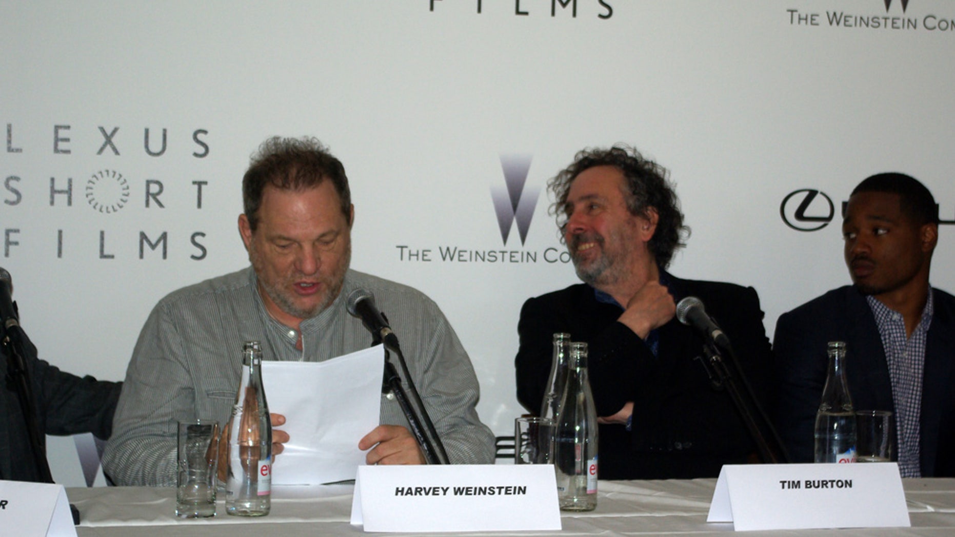 Tim Burton and Harvey Weinstein speak at the Cannes Film Festival.
