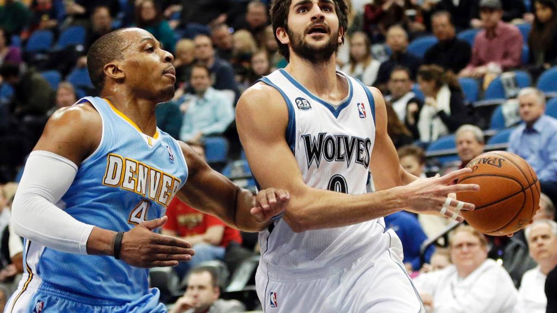 FILE - In this Feb. 12, 2014, file photo, Minnesota Timberwolves' Ricky Rubio, right, of Spain, lays up a shot as Denver Nuggets's Randy Foye defends in the first quarter of an NBA basketball game in Minneapolis. The clock is ticking on the Timberwolves and Rubio to get an extension done. If the two sides don't reach agreement by Oct. 31, Rubio can become a restricted free agent next summer. (AP Photo/Jim Mone, File)