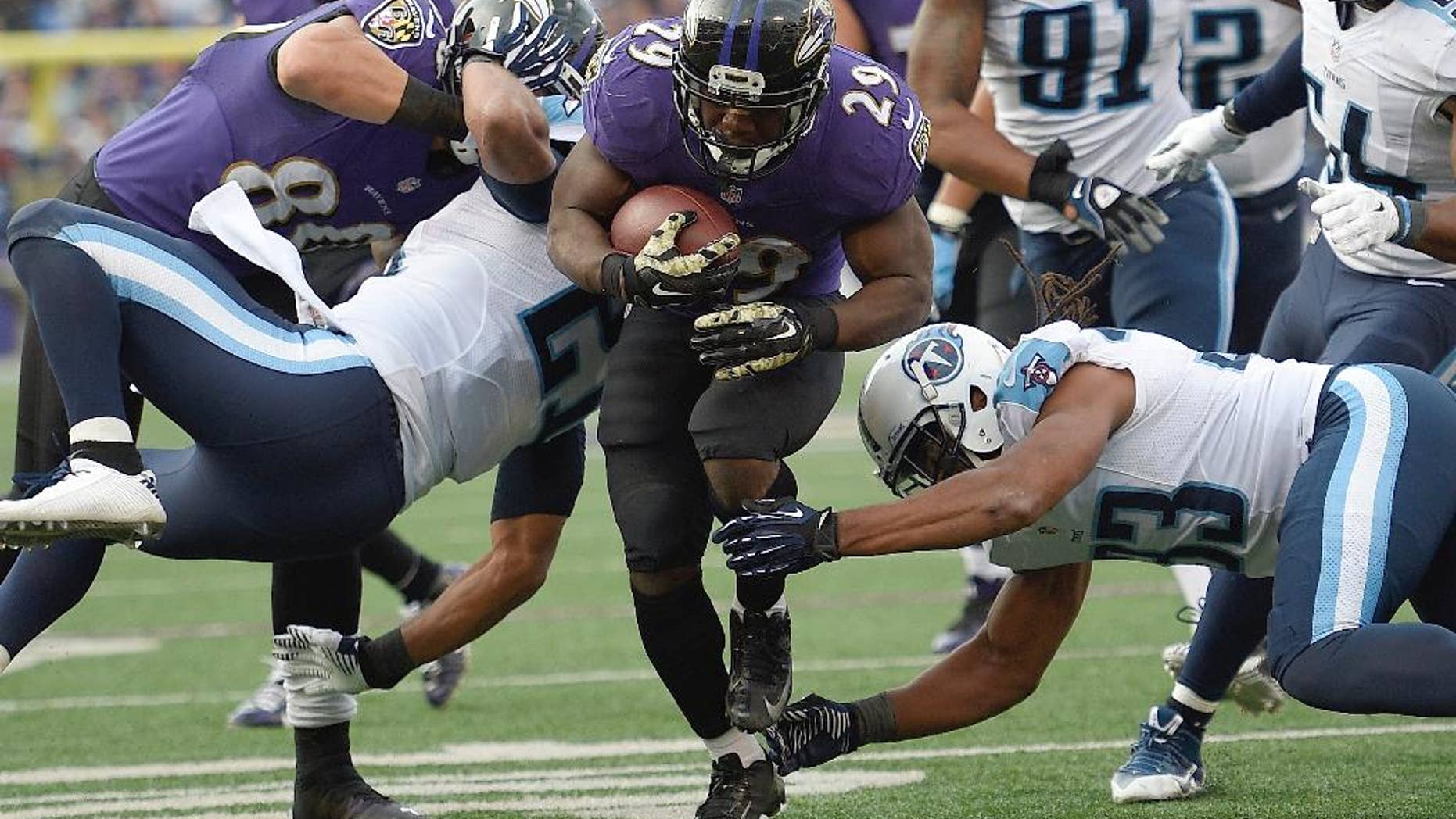 Baltimore Ravens running back Justin Forsett (29) slips past Tennessee Titans free safety Michael Griffin (33) and runs for a touchdown during the second half of an NFL football game in Baltimore, Sunday, Nov. 9, 2014. (AP Photo/Nick Wass)