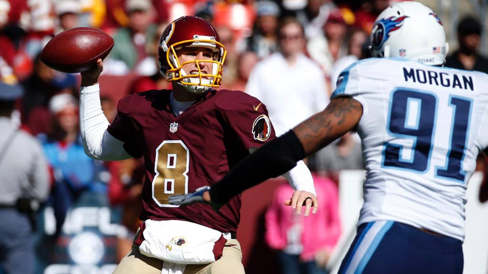 Washington Redskins quarterback Kirk Cousins (8) throws under pressure from Tennessee Titans outside linebacker Derrick Morgan (91) during the first half of an NFL football game, Sunday, Oct. 19, 2014, in Landover, Md. (AP Photo/Alex Brandon)