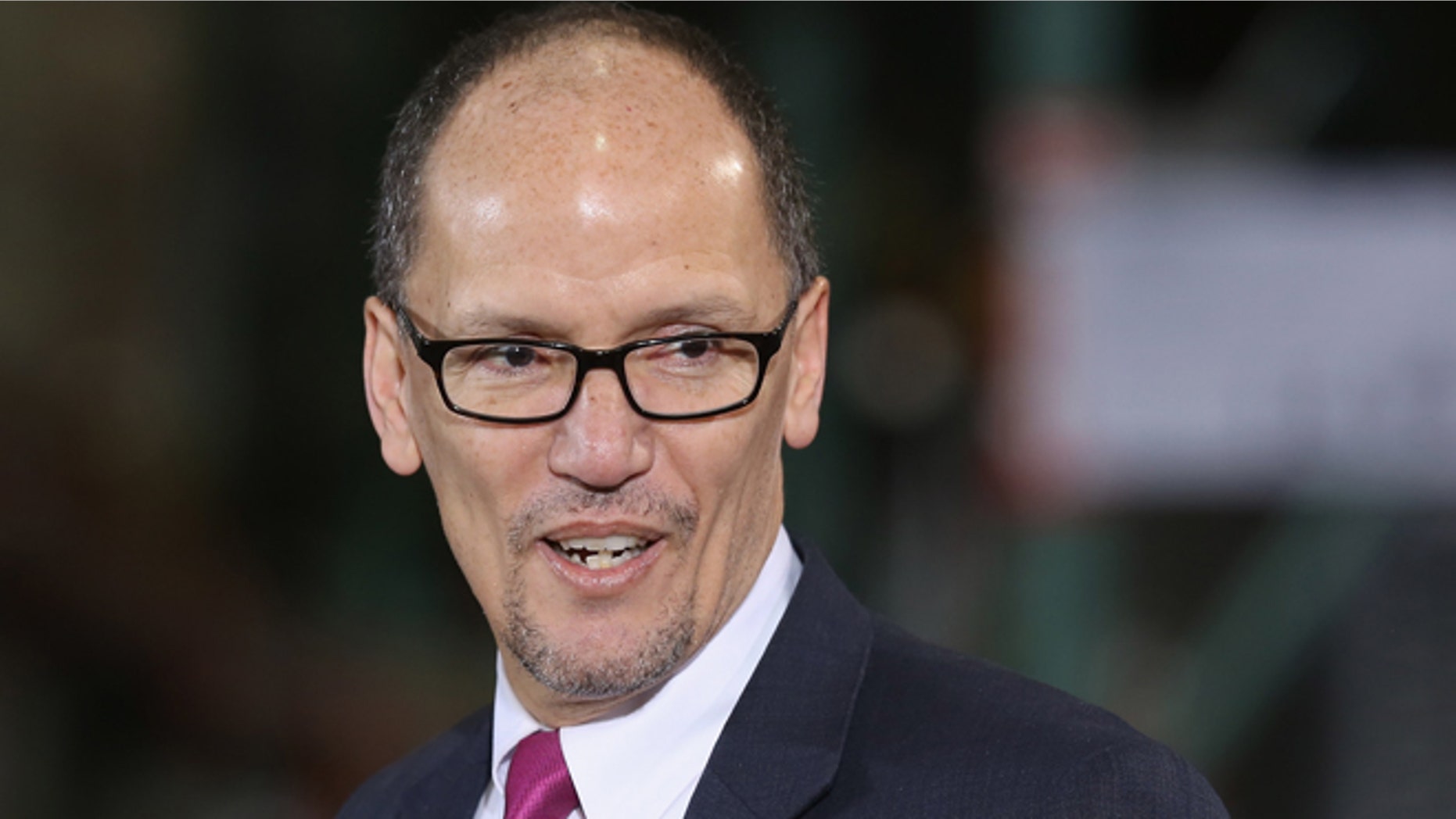 LANHAM, MD - JANUARY 29: U.S. Labor Secretary Tom Perez holds up his Costco membership cared before U.S. President Barack Obama takes the stage at a Costco store January 29, 2014 in Lanham, Maryland. (Photo by Chip Somodevilla/Getty Images)