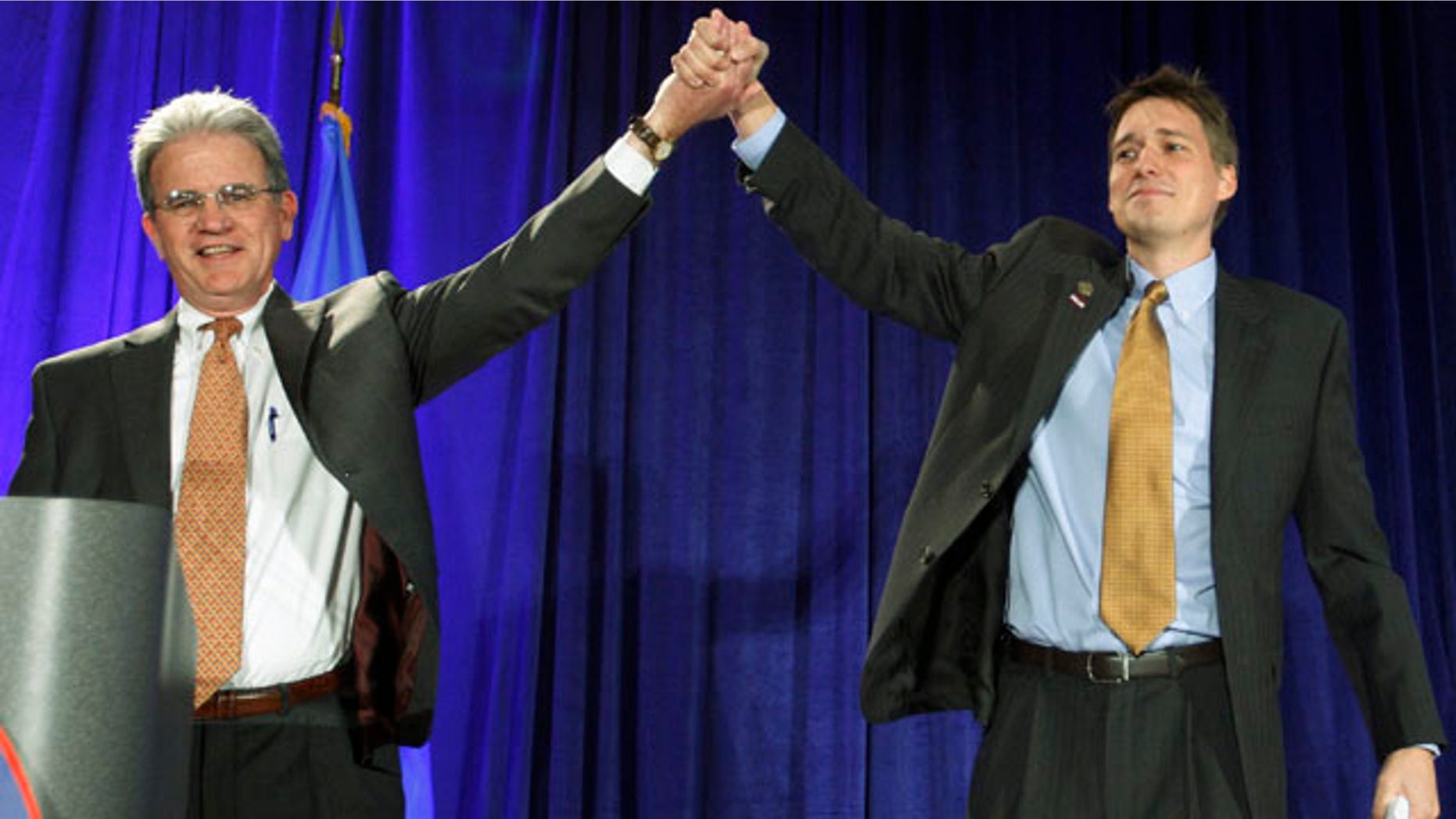 Nov. 2: Matt Pinnell, right, Oklahoma GOP chairman, lifts up the arm of U.S. Senator Tom Coburn, left, at a Republican watch party in Oklahoma City.